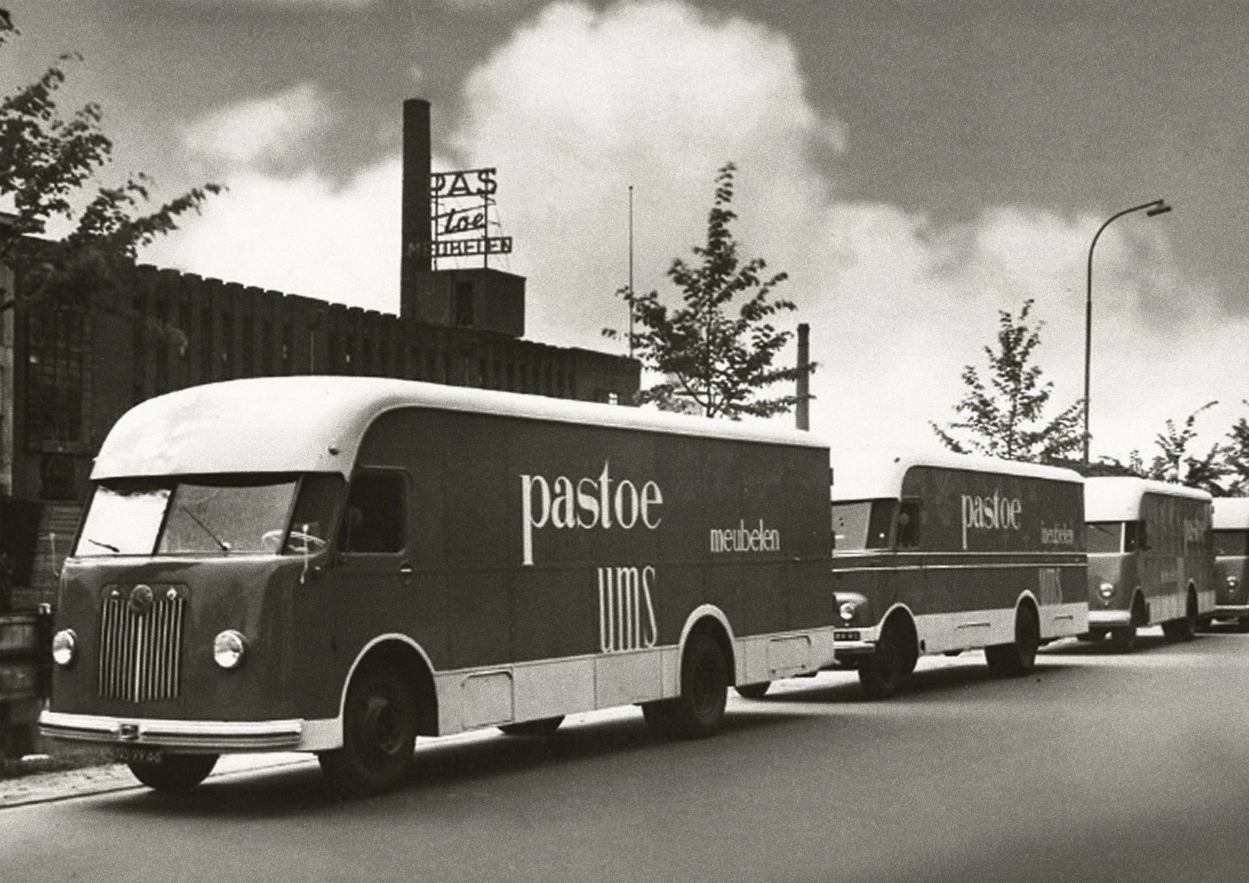 Vintage black-and-white photo of Pastoe delivery trucks, timeless dutch furniture design, branding project by Automne Studio.