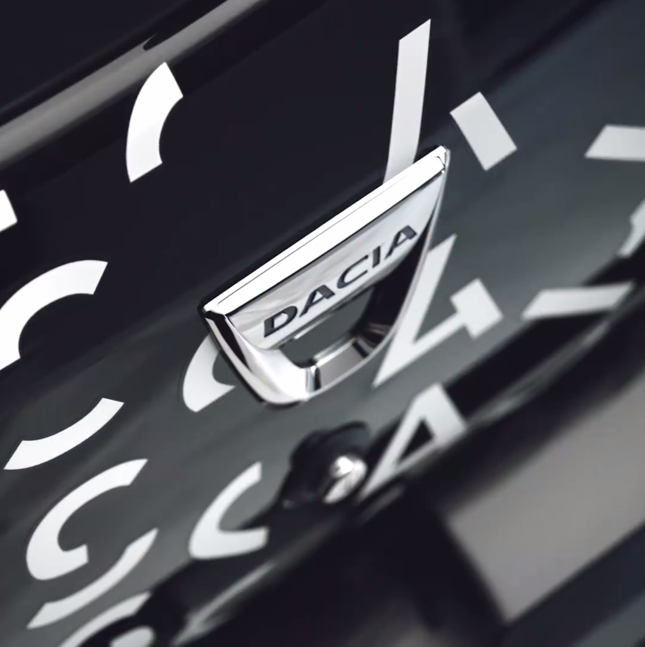 Close-up of a black Dacia Sandero Escape Limited Edition, typography by Automne Studio.