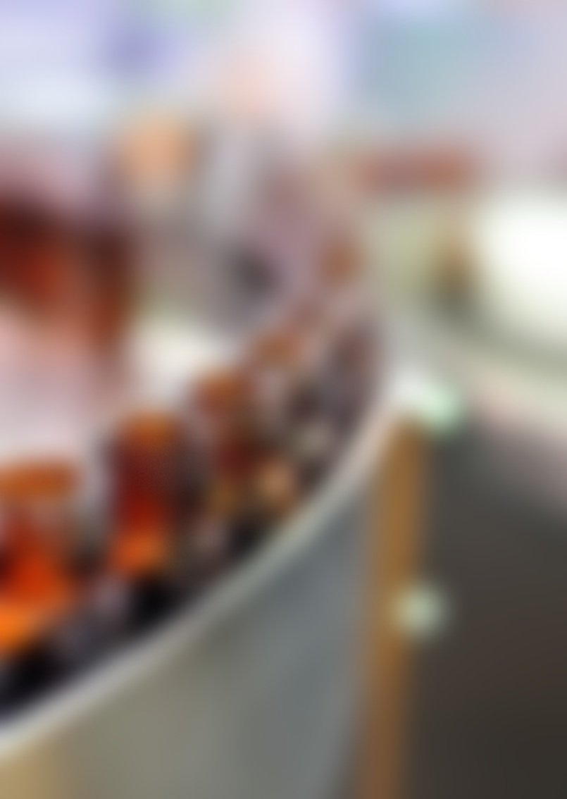 Blurred image of a conveyor belt with brown bottles