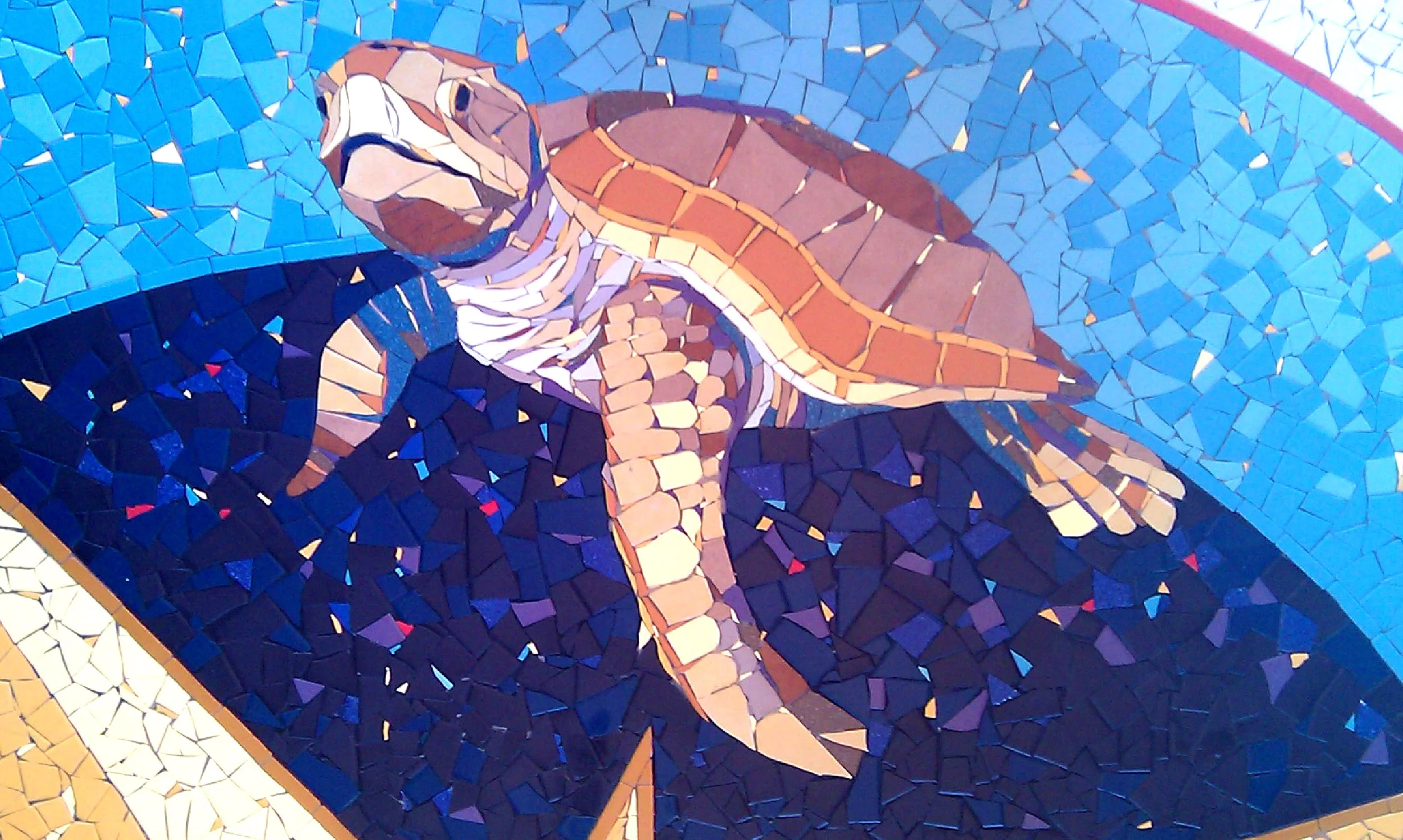 Mosaic of a turtle in a water setting.