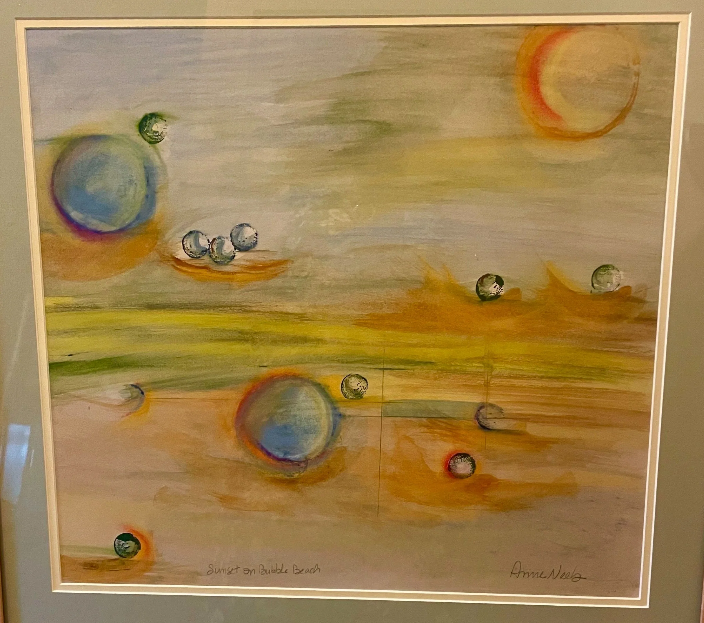 Ann Neeb. Abstract sunset scene with colorful spheres and a sky featuring a crescent and full moon over a bubble beach.