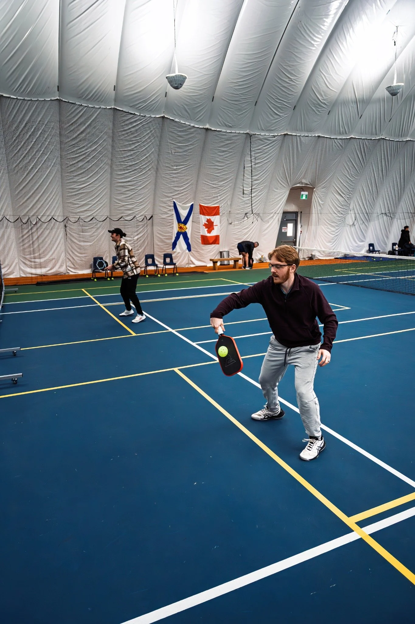 Pickleball player competing on an indoor court in Atlantic Canada