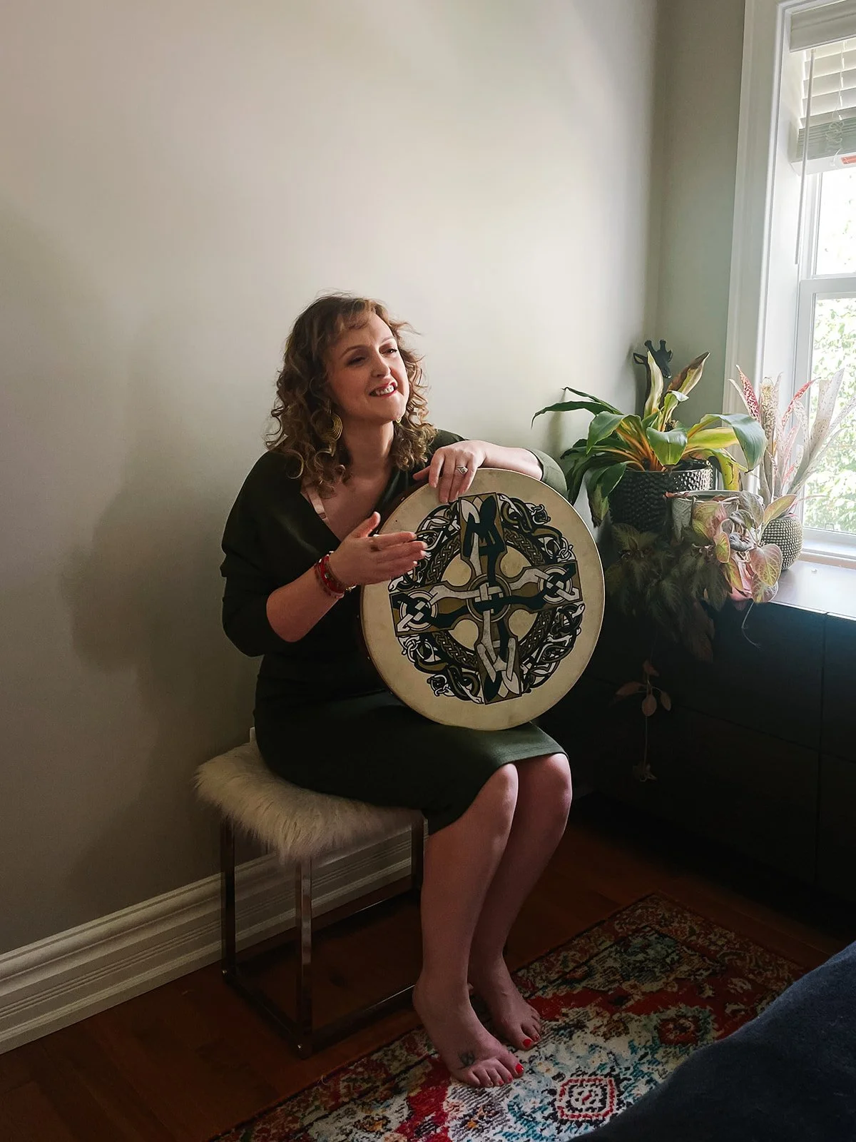 moyra-playing-bodhran-laughing-in-green-dress.jpg
