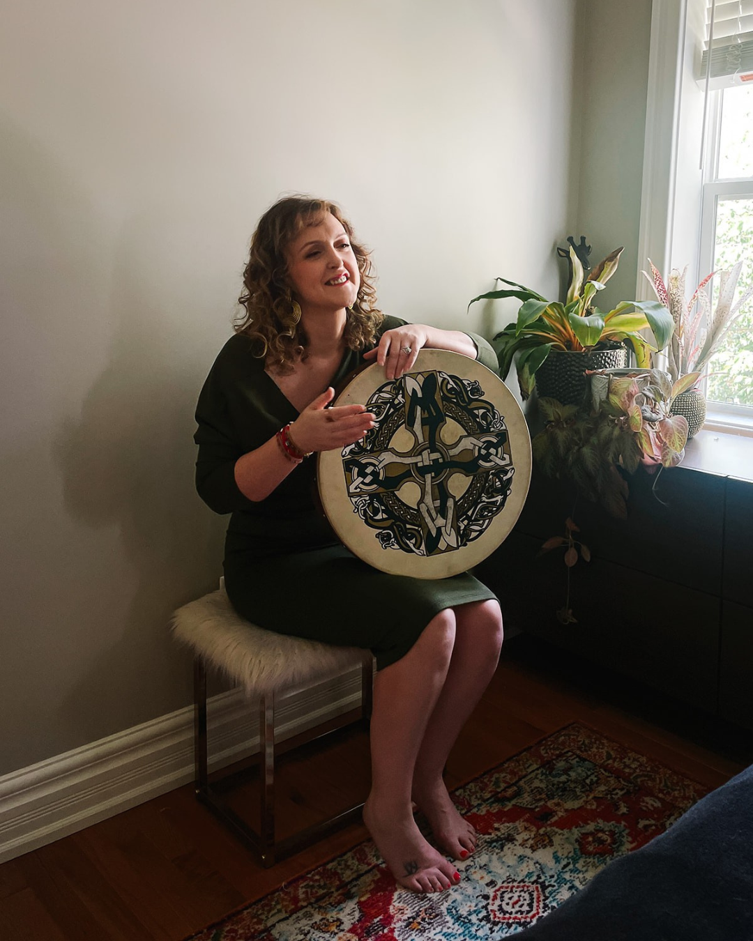 moyra-playing-bodhran-laughing-in-green-dress.jpg