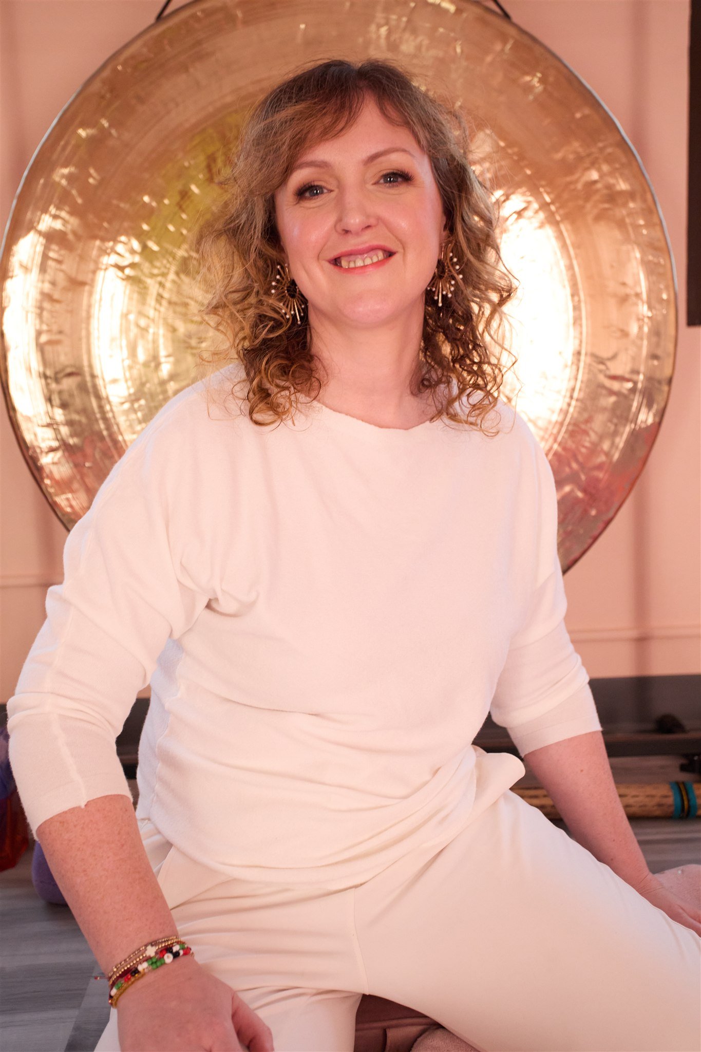 moyra-lakewood-studio-smiling-with-gong.jpg