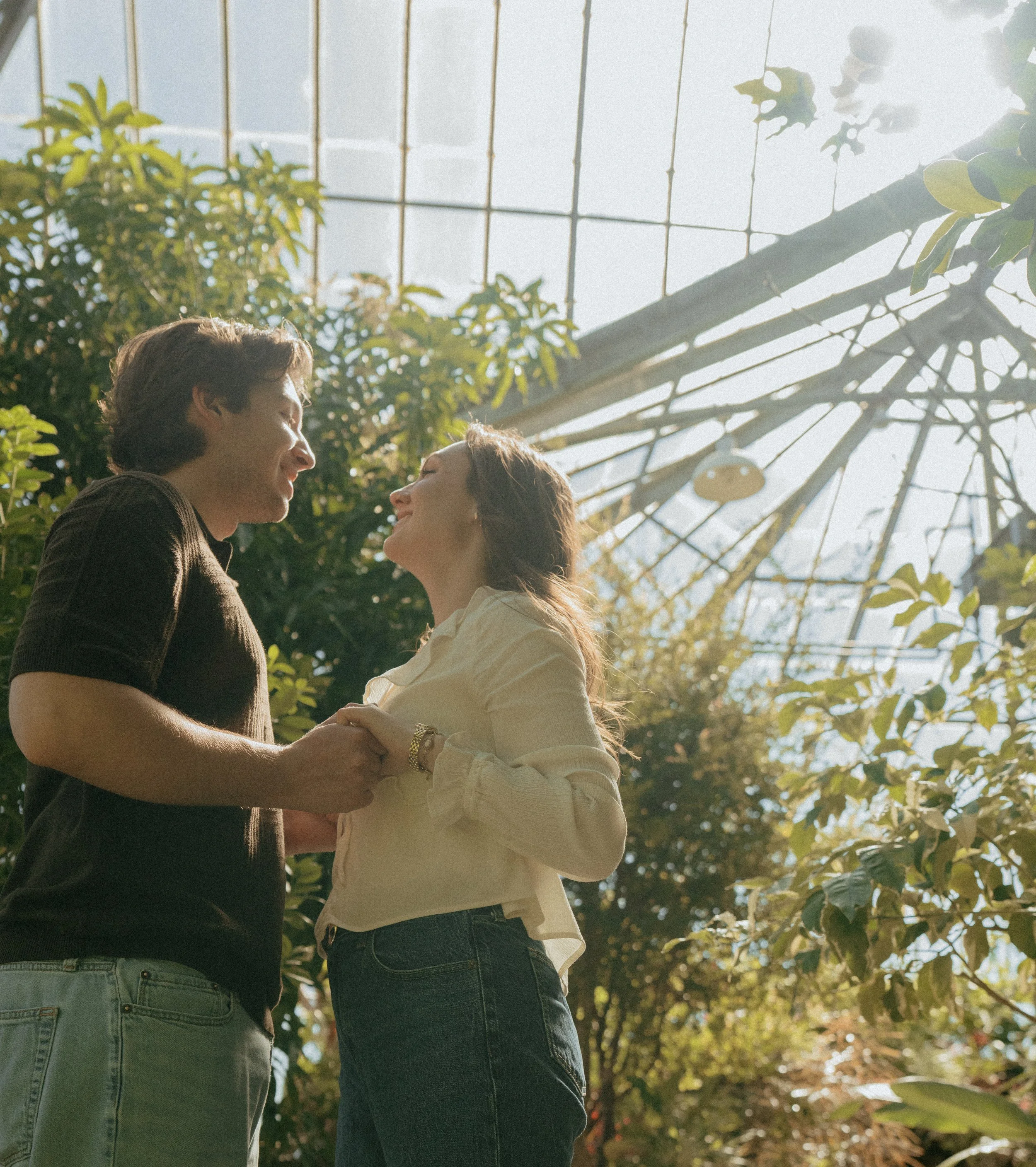 A couple holding hands together at the Belle Isle Conservatory in Detroit Michigan.