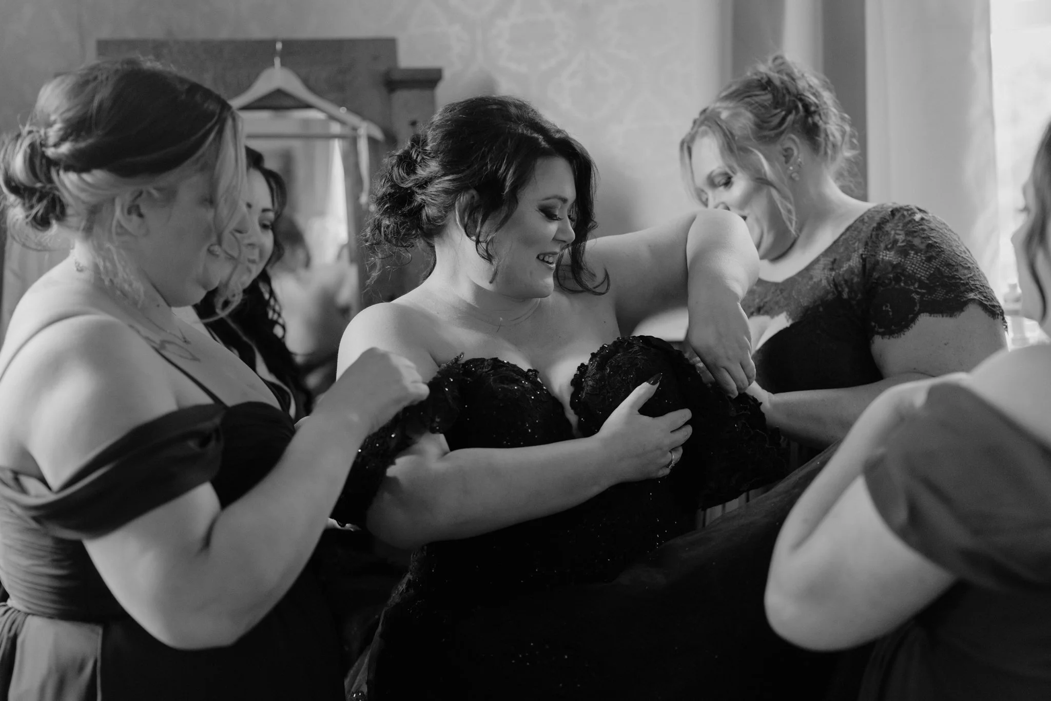 Bride getting her wedding dress on on her wedding day