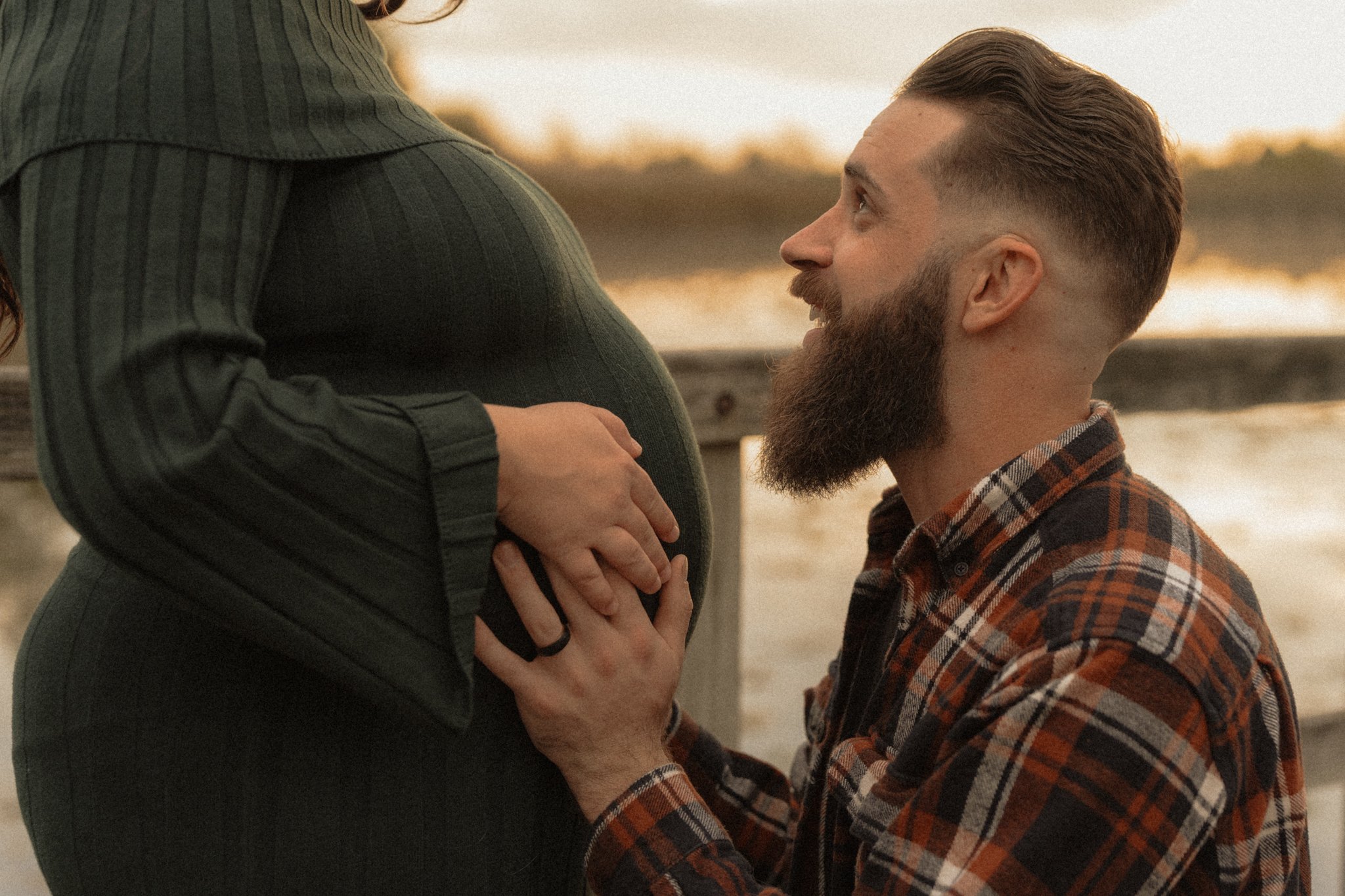 Father to be holding baby bump.