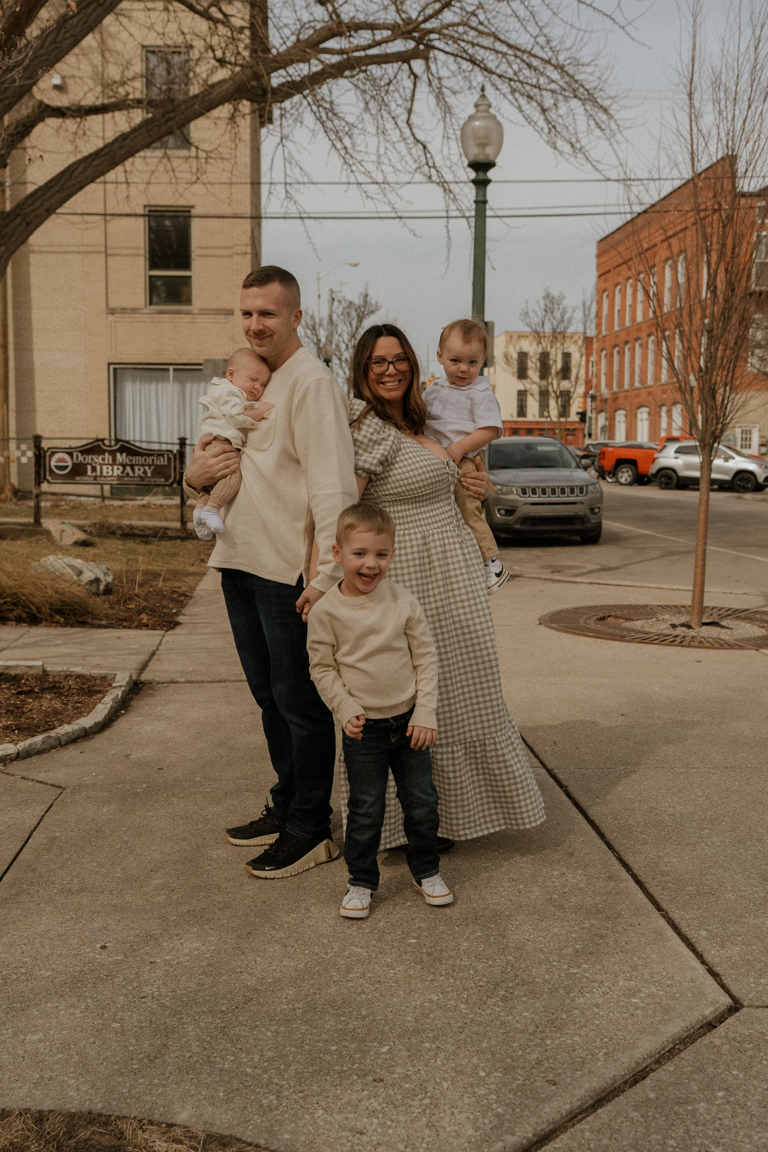 Cute family standing in downtown Monroe Michigan together.