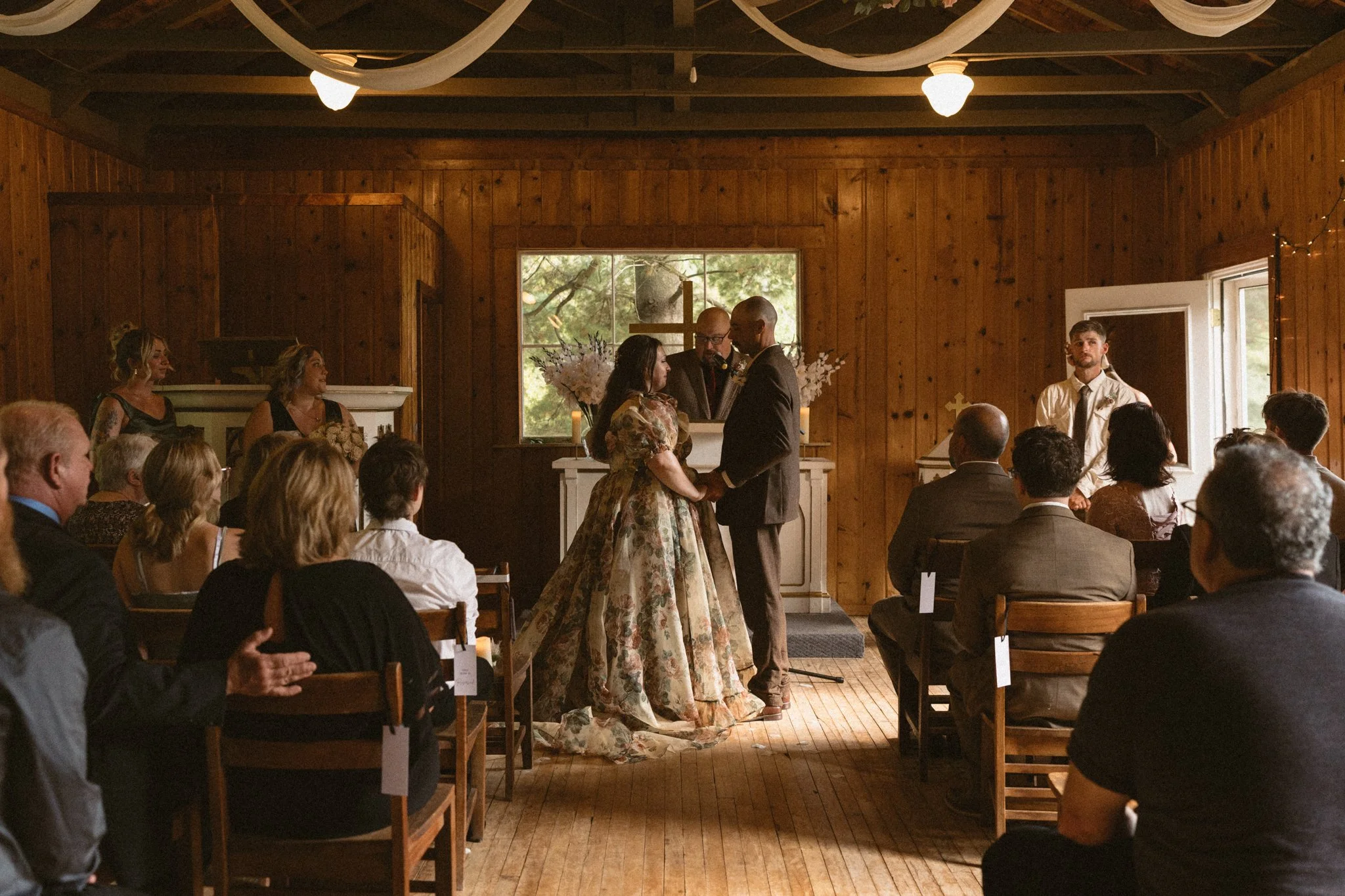 Bride and Groom getting married in an old chapel surrounded by family and friends.