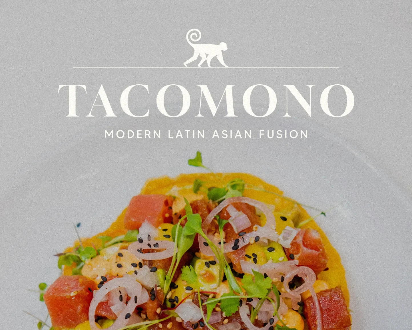 A close-up of a plate of modern Latin Asian fusion cuisine with chopped vegetables and herbs, placed below the Tacomono restaurant logo.