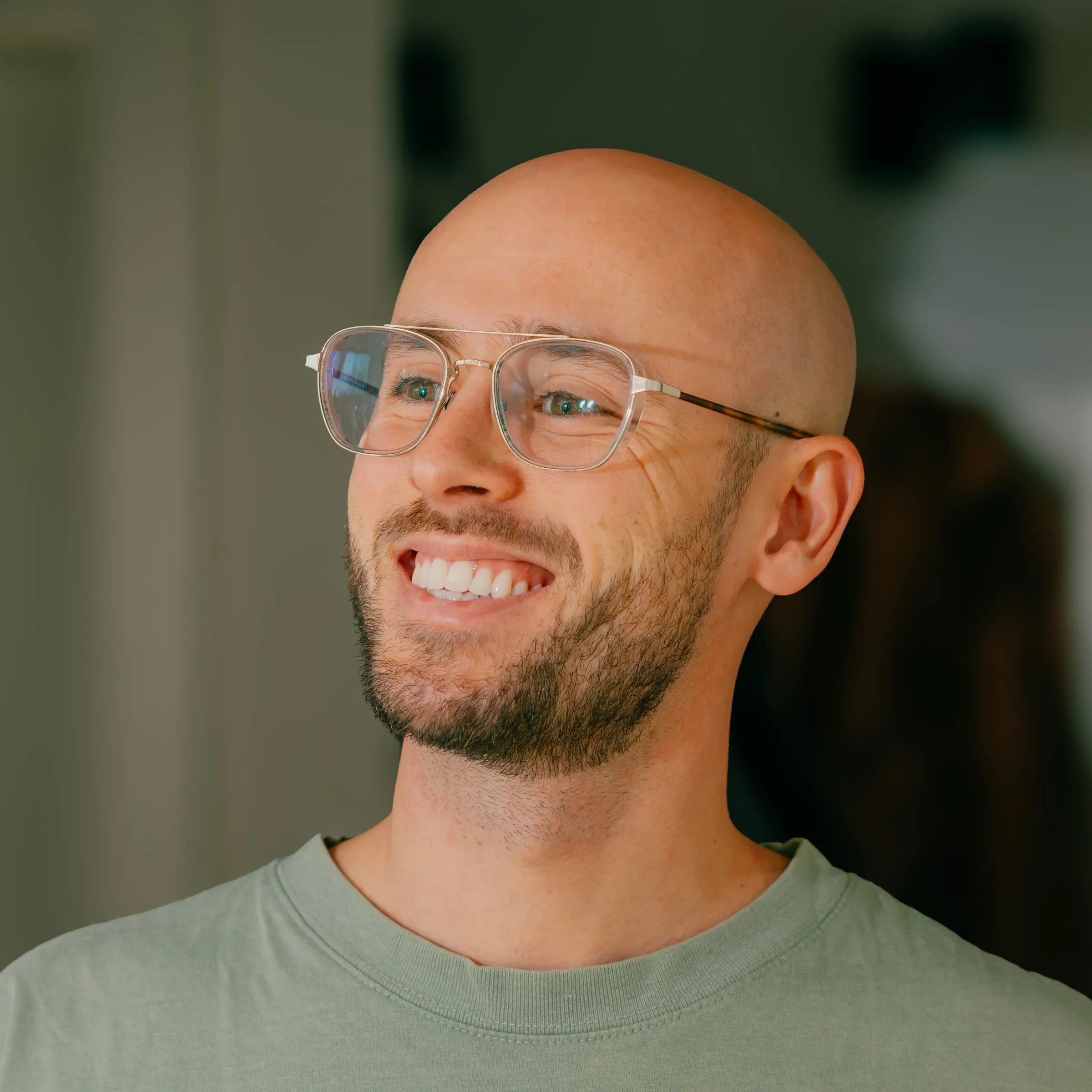 A smiling man with glasses and a beard