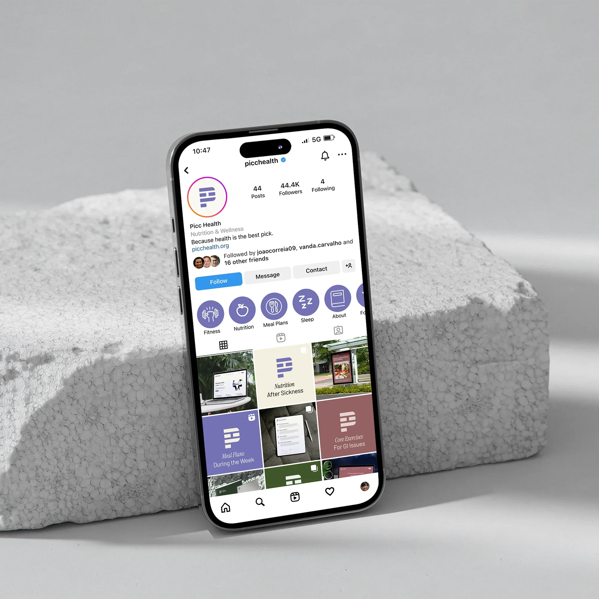 An iPhone displaying the Instagram profile of Picc Health, a nutrition and wellness account, resting on a textured white surface against a plain background.