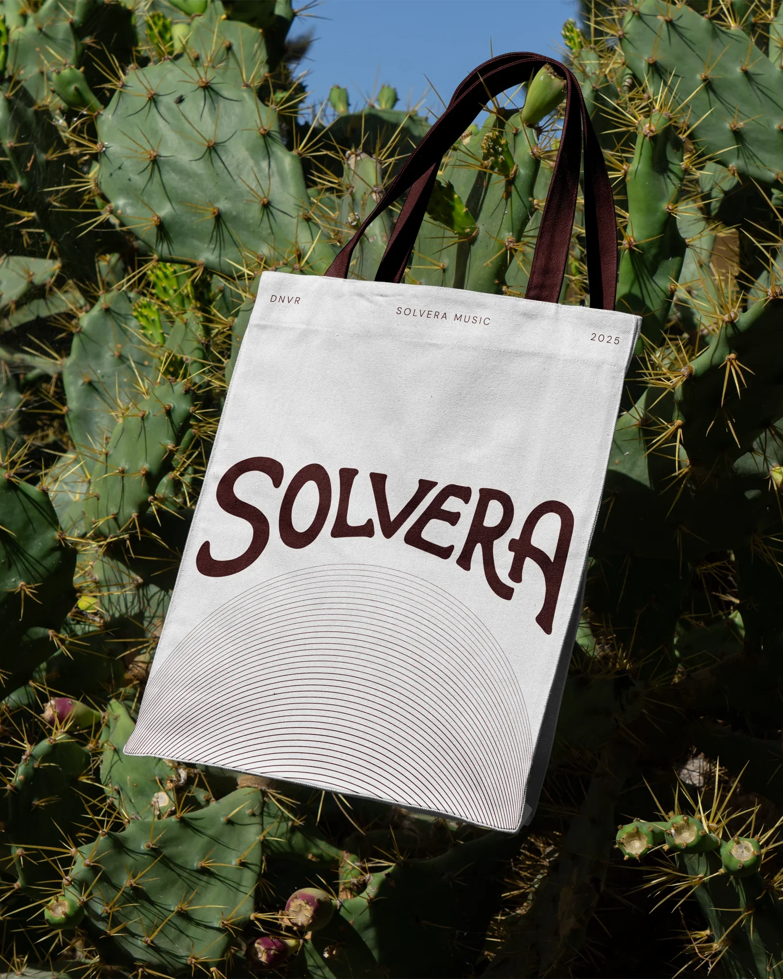 Black and white photo of a man wearing sunglasses, smoking a cigar, holding a saxophone, and looking to the right. The word "SOUVER" is in bold white letters at the top, with "Denver, CO" and "2024" at the bottom.