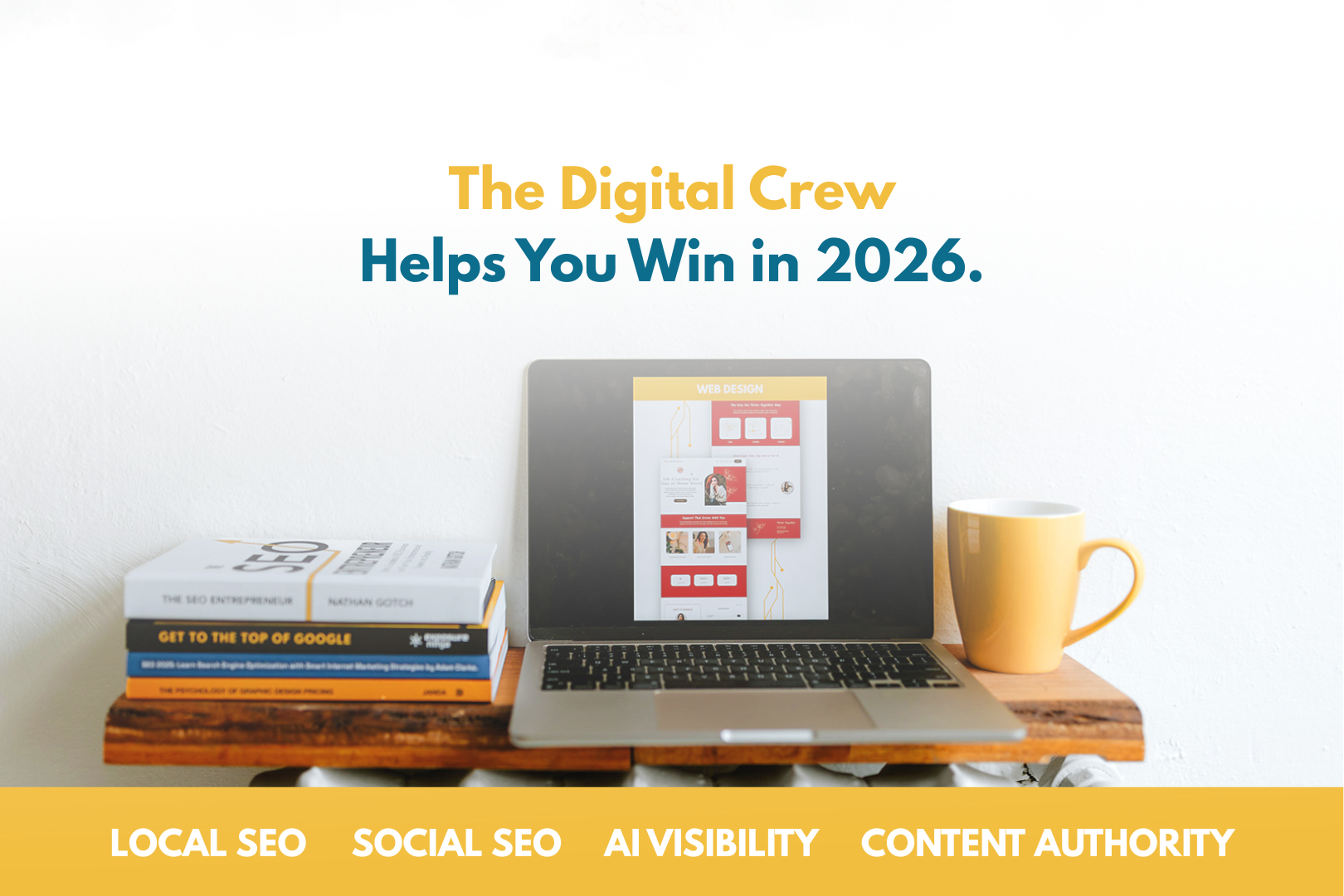 Text reads The Digital Crew Helps You Win In 2026. A laptop is sitting on a wood panel next to books about SEO.