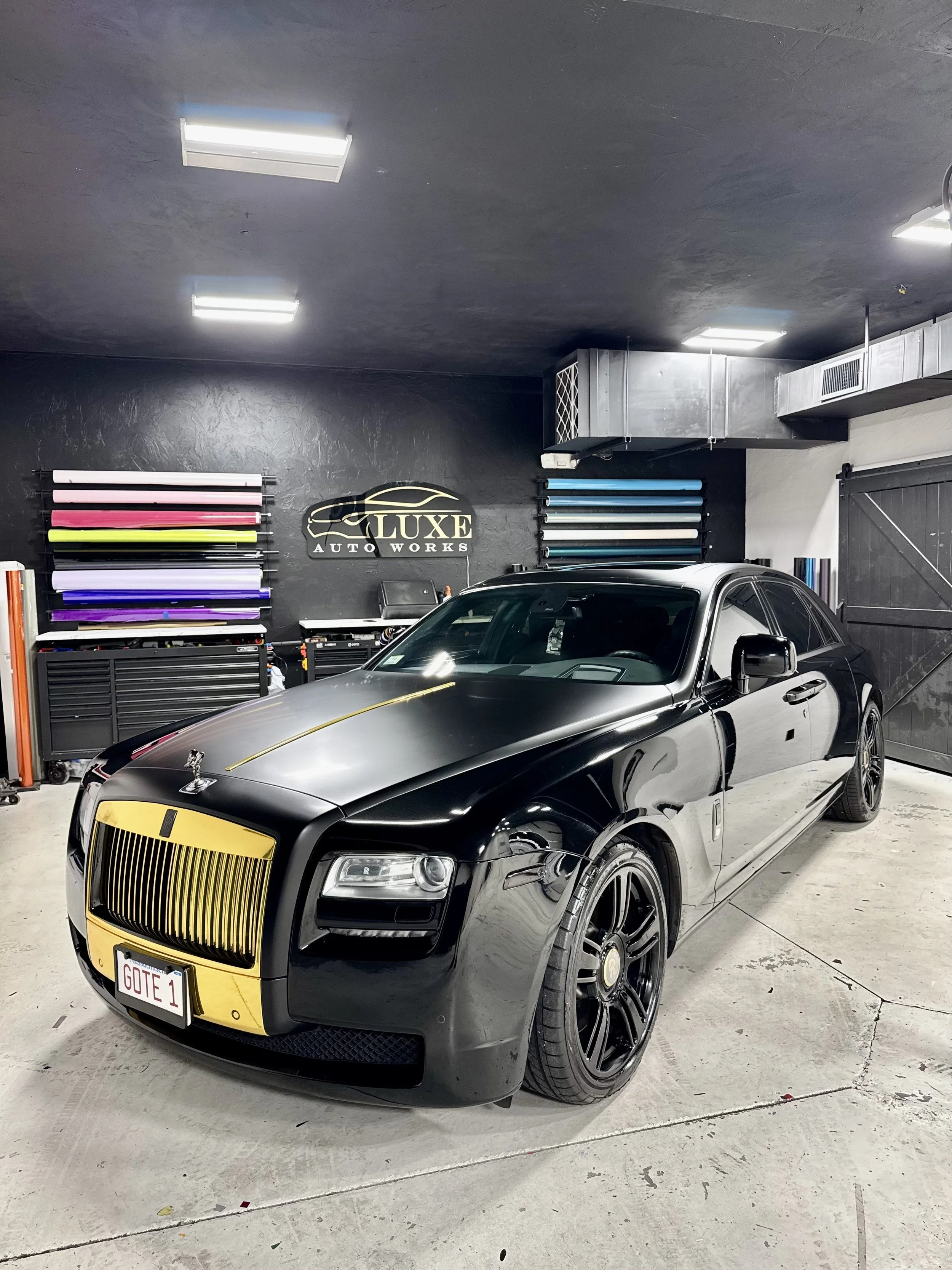 Rolls Royce Ghost black vinyl wrap with gold accents at Luxe Auto Works in Worcester Massachusetts