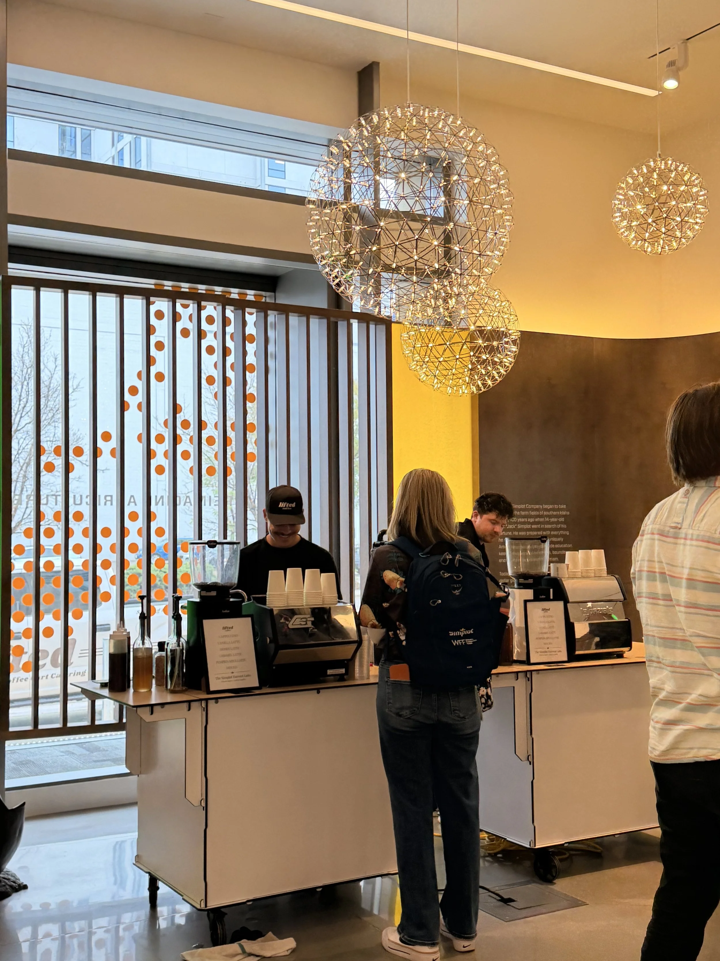Lifted Coffee Cart barista serving corporate event guests on a rooftop in downtown Boise Idaho with city and mountain views