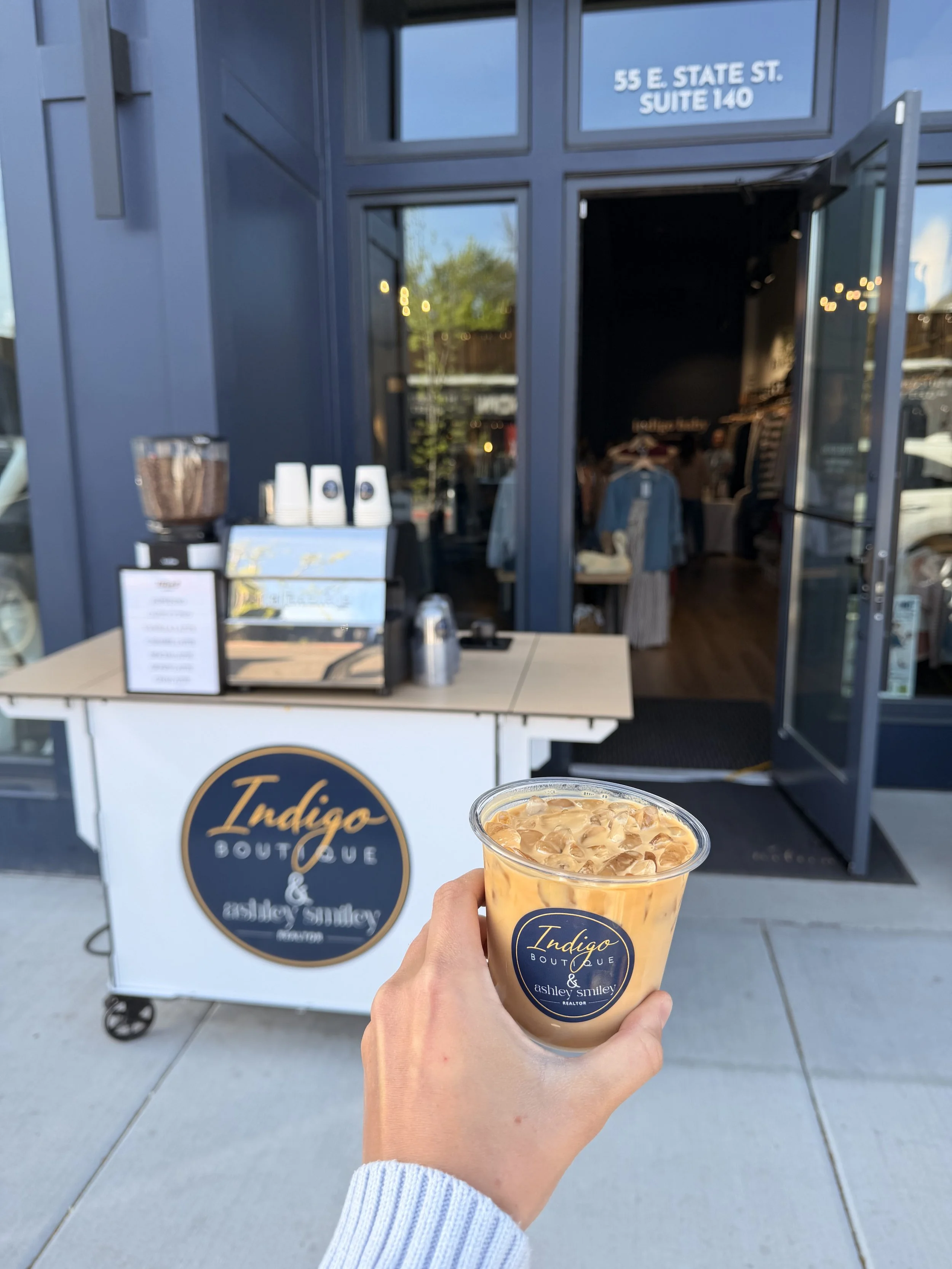 Lifted Coffee Cart serving a custom branded iced latte at a grand opening brand activation event in Boise Idaho