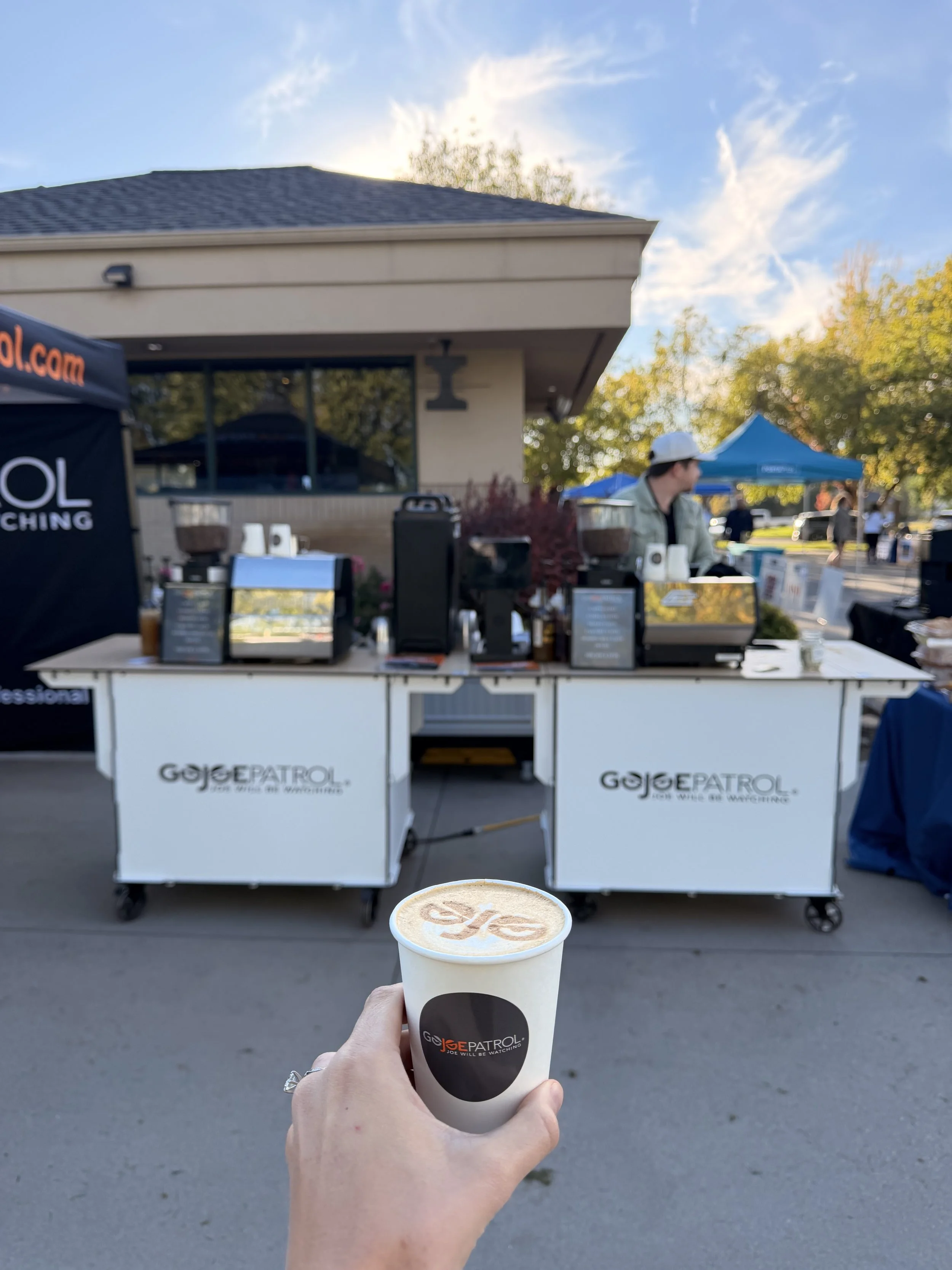 Lifted Coffee Cart barista serving corporate event guests on a rooftop in downtown Boise Idaho with city and mountain views