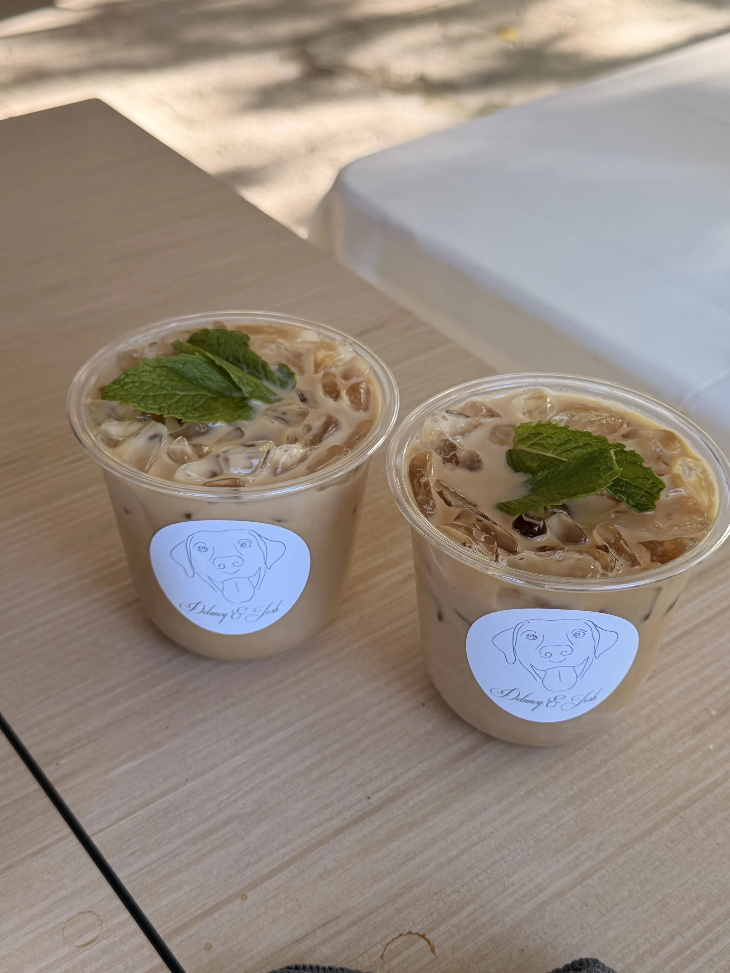 Custom branded iced lattes with couple's logo served by Lifted Coffee Cart at a Boise Idaho wedding