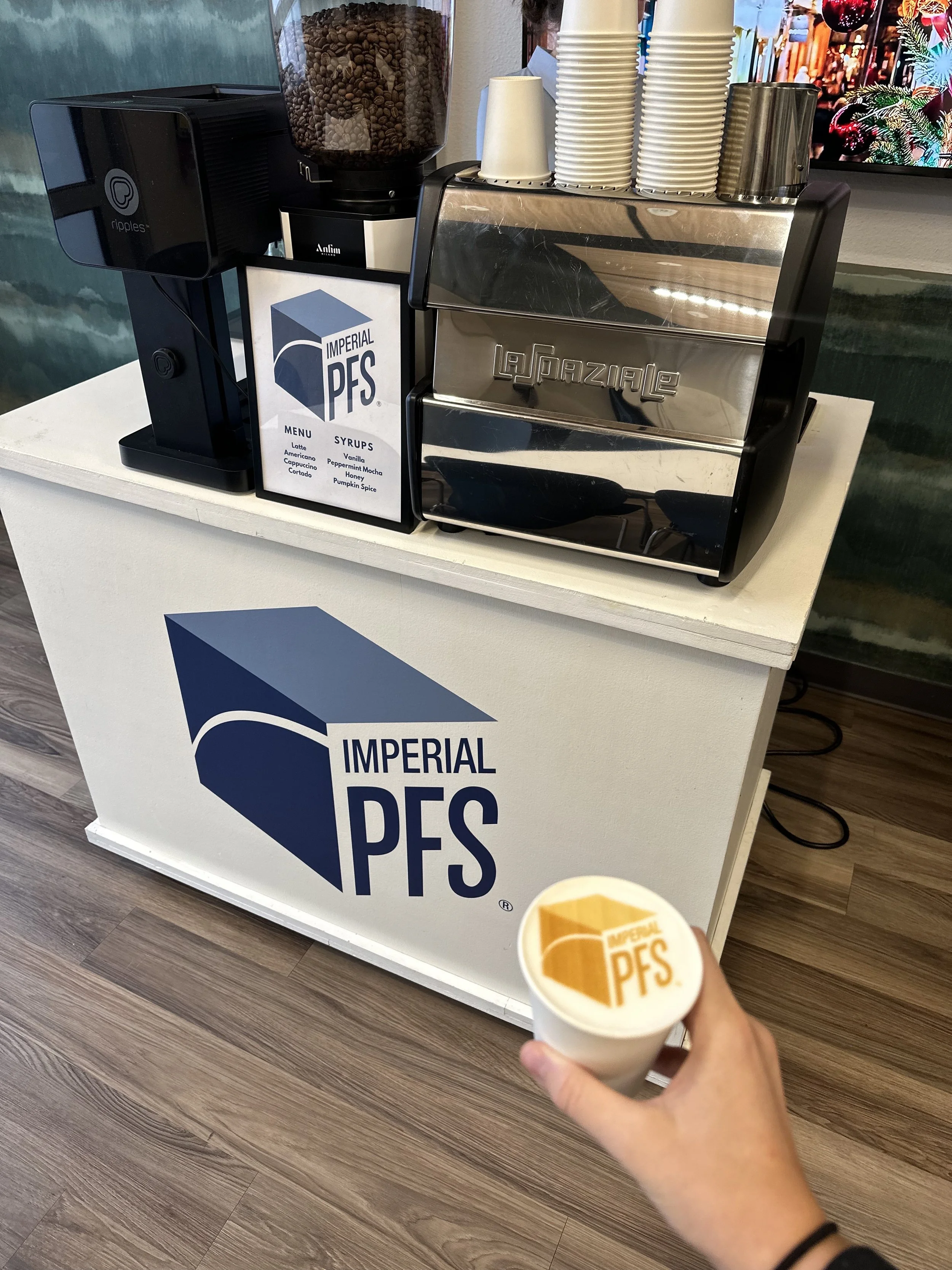 Lifted Coffee mobile espresso cart serving specialty coffee at private events. Custom branded bar, cups, drinks, menu and latte logo printed prints image on top of latte