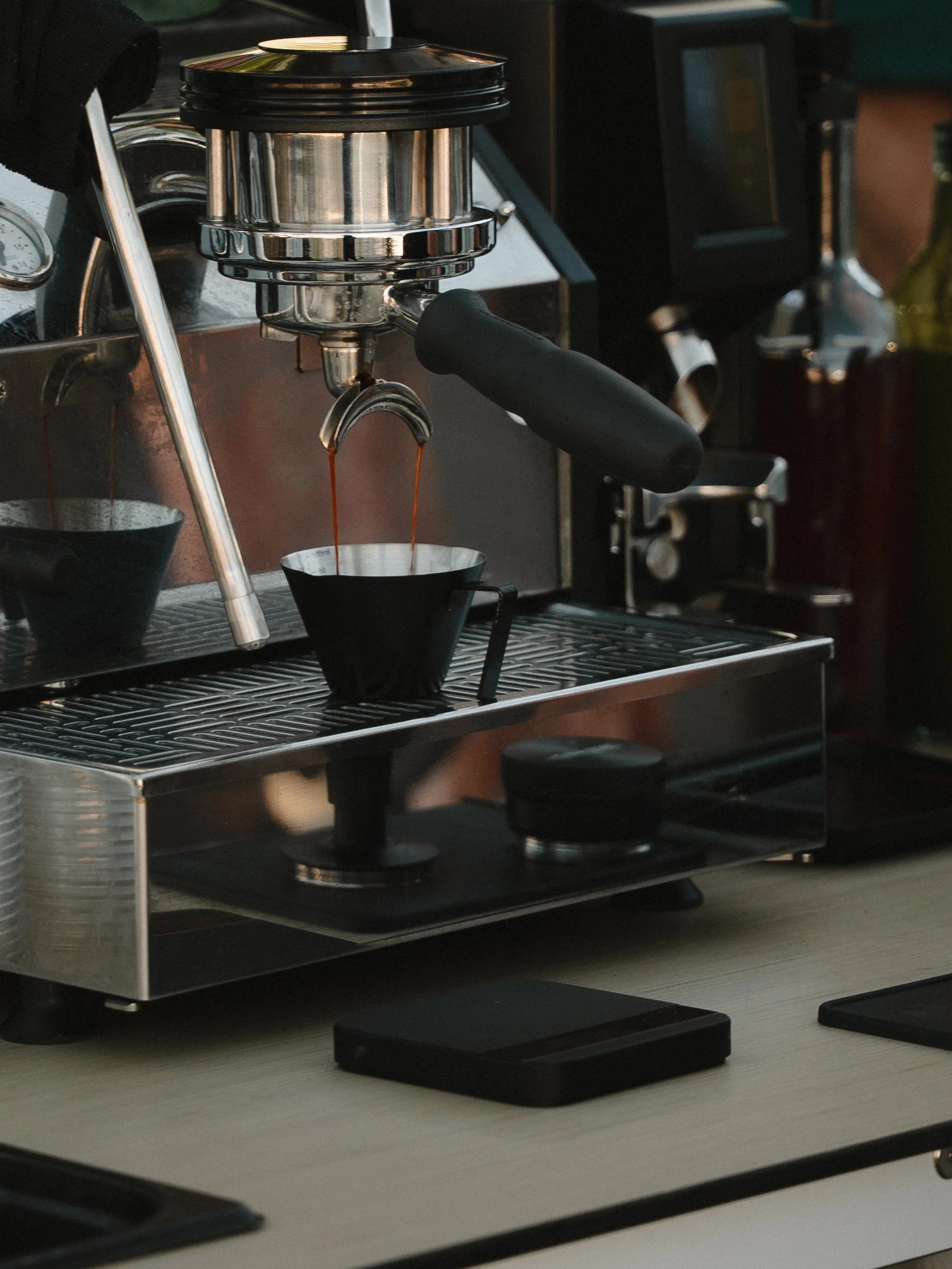 Professional barista serving espresso drinks at a Boise conference and expo