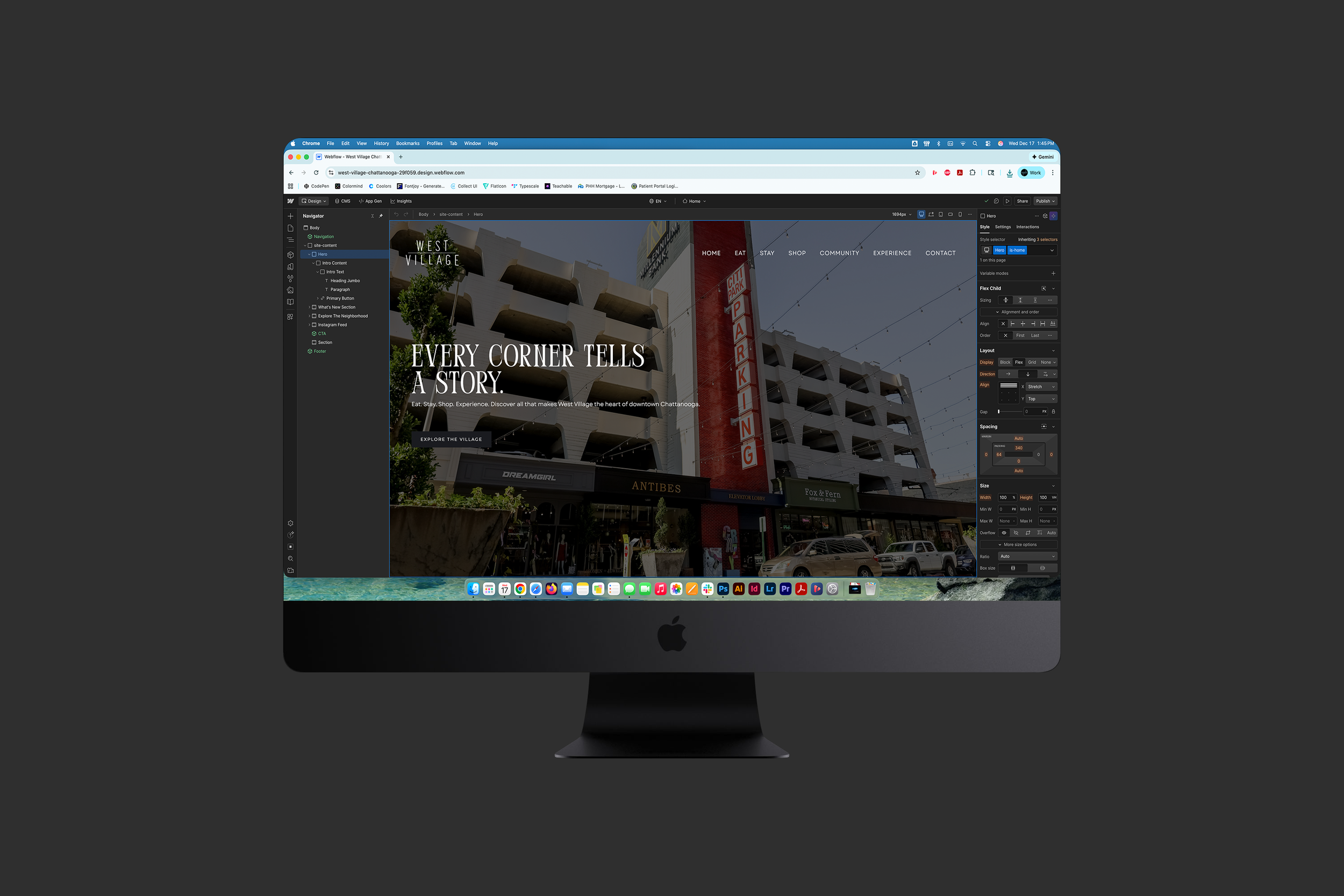 An iMac computer displaying a webpage design for West Village, featuring a building with a parking sign, various storefronts, and the text "Every corner tells a story."