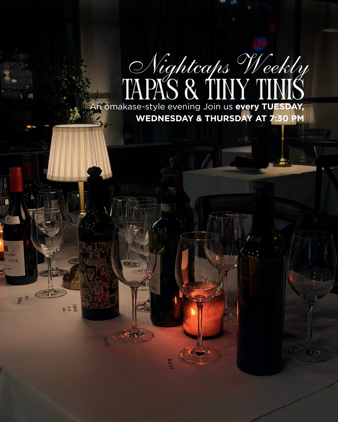 A dimly lit restaurant table set with wine bottles, glasses, a lit candle, and a table lamp, with an overlay promotional text for Nightcaps Weekly Tapas & Tiny Tins event.