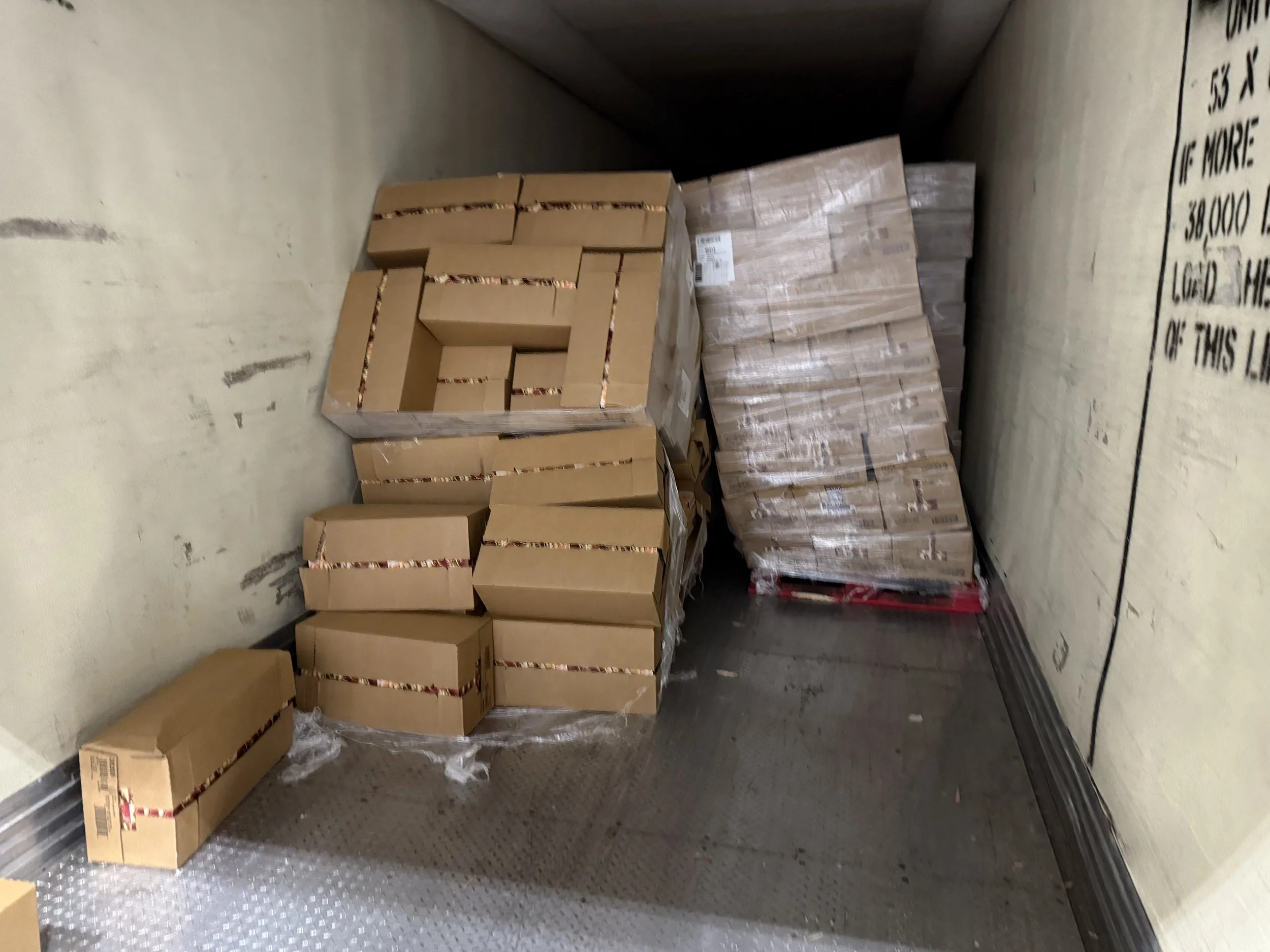 Stacked cardboard boxes in a storage area or truck