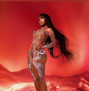 Person wearing futuristic, decorative outfit standing against a red abstract background.
