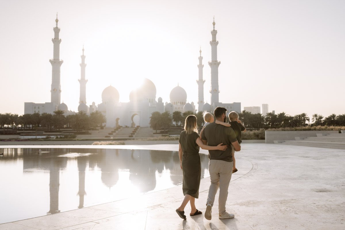 family walking towards sunset in wahat al karama