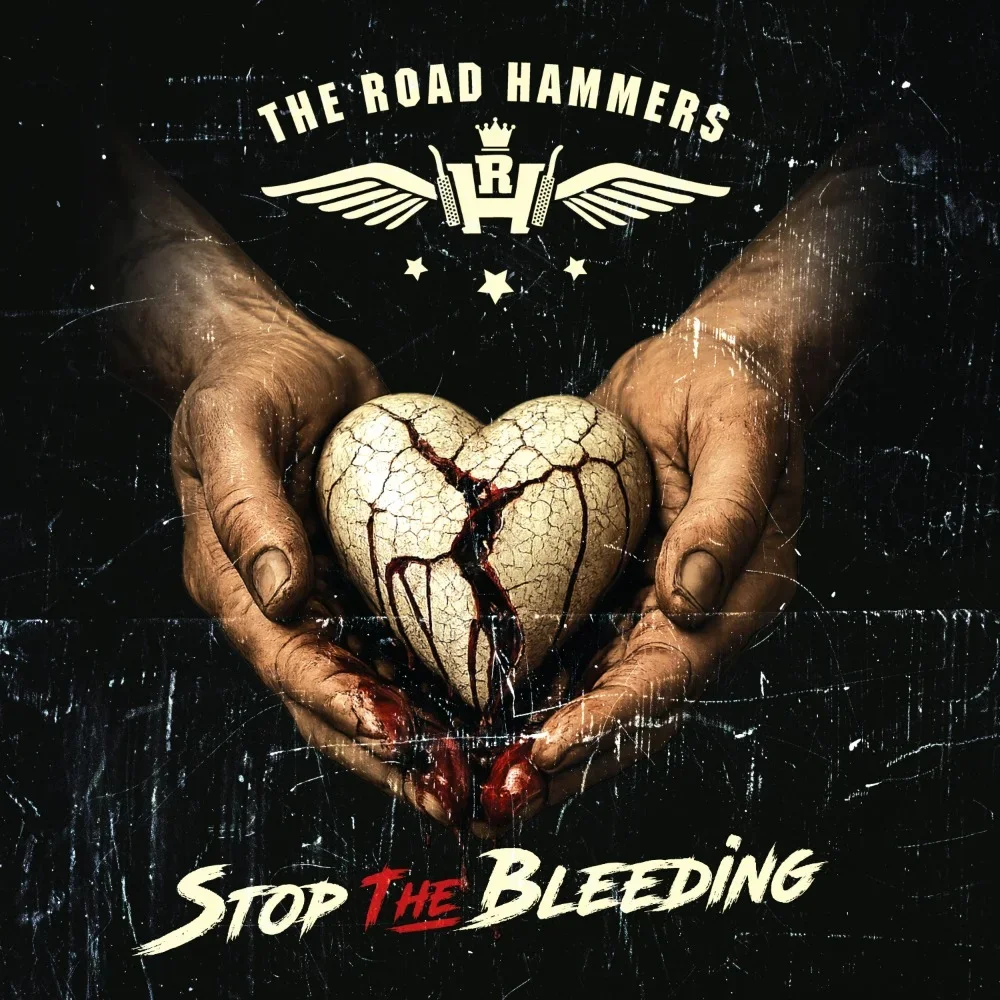 A pair of dirty hands holding a cracked, heart-shaped object with blood dripping from it. The image has a gritty, distressed look, with the text 'Stop The Bleeding' and 'The Road Hammers' at the top.