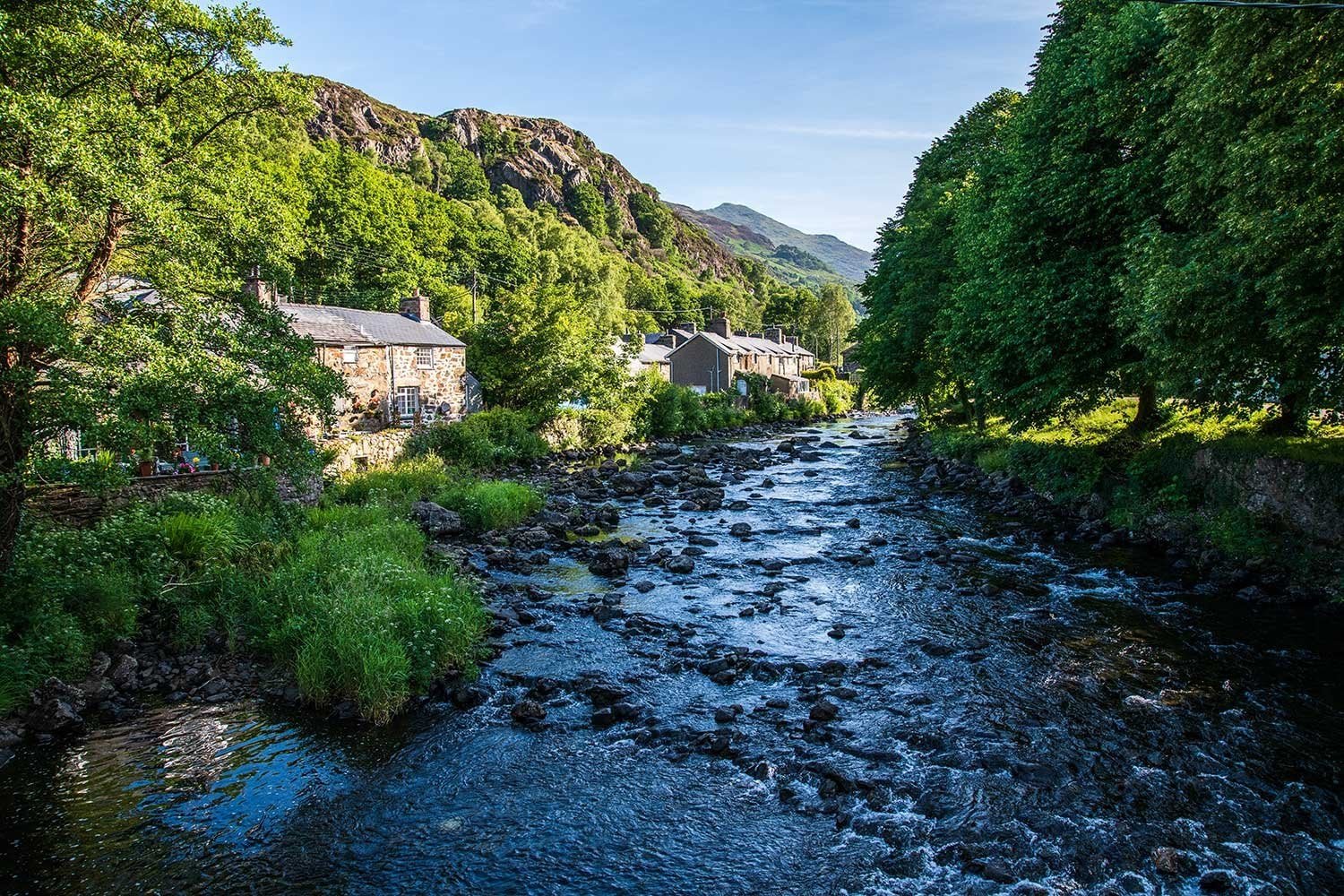 The Afon Glaslyn flowing into Beddgelert, lined by lovely stone cottages