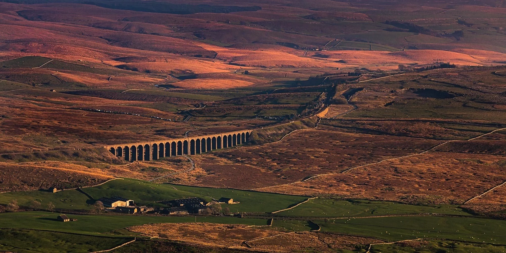 Ribblehead Viaduct stretching across moorland, viewed from Whernside, Yorkshire Dales.