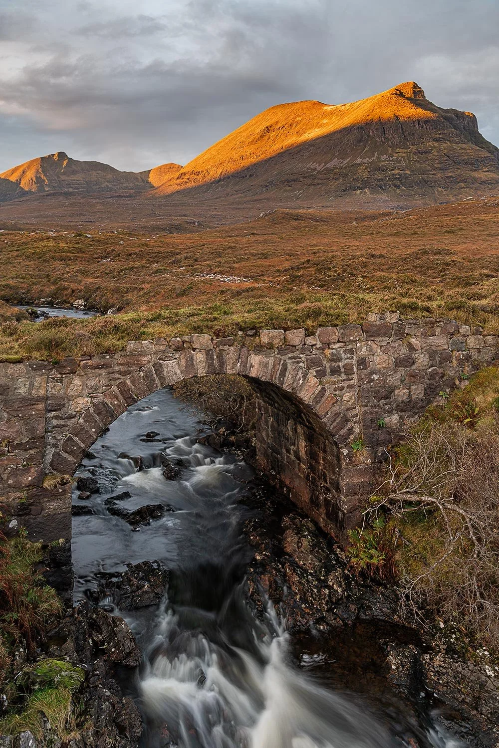 Assynt waterfall at sunrise with the mountain backdrop of Quinag and Sail Gharbh.