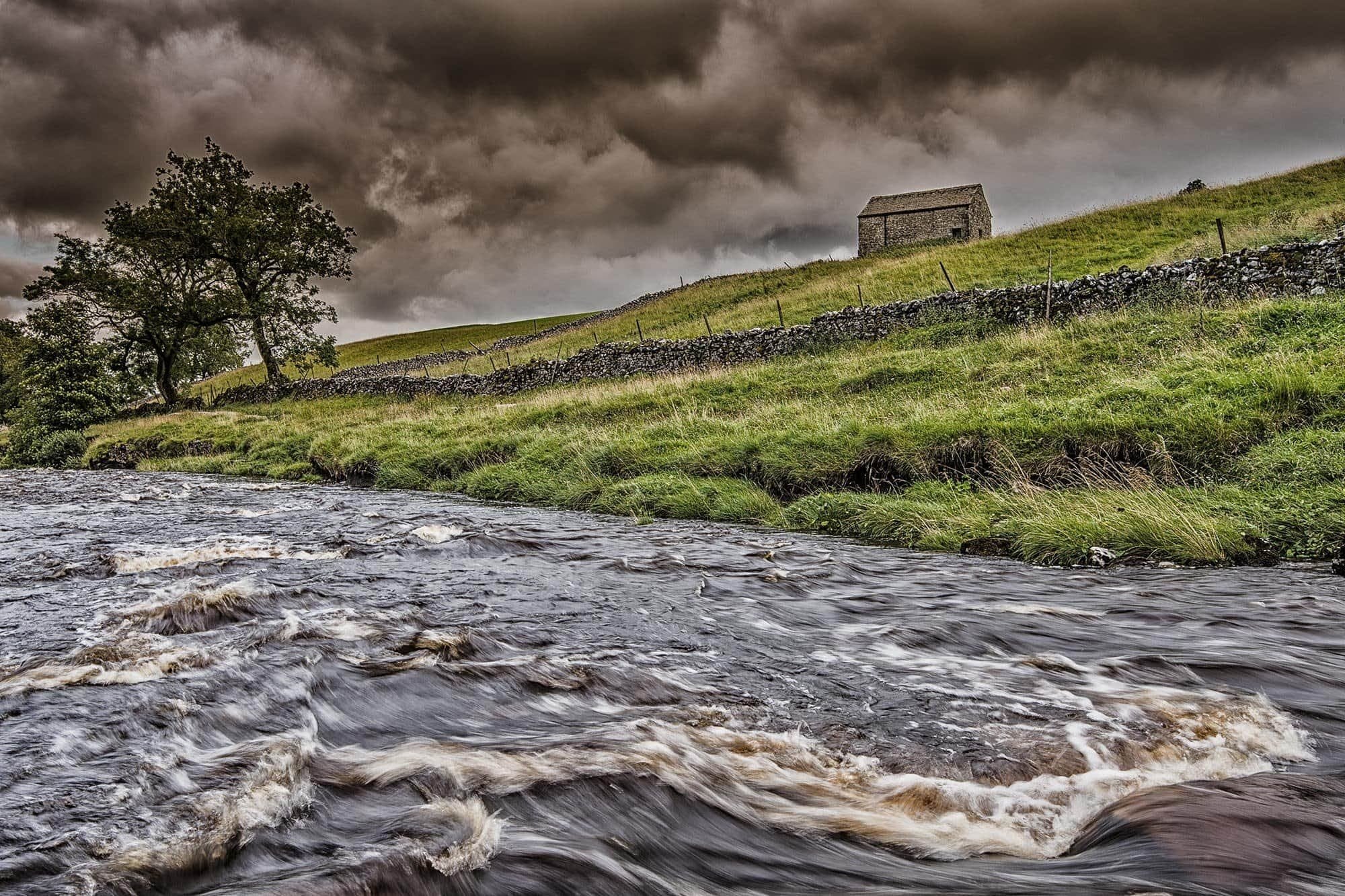 Dark storm clouds rolling in over the River Wharfe, Yorkshire Dales.