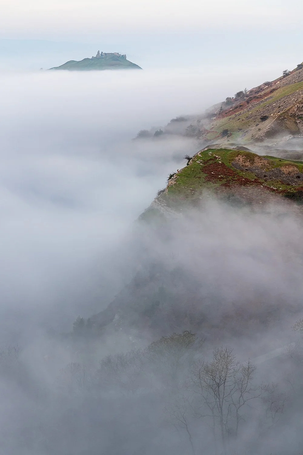 An atmospheric morning as mist surrounds Castell Dinas Bran above the Dee Valley near Llangollen North Wales.