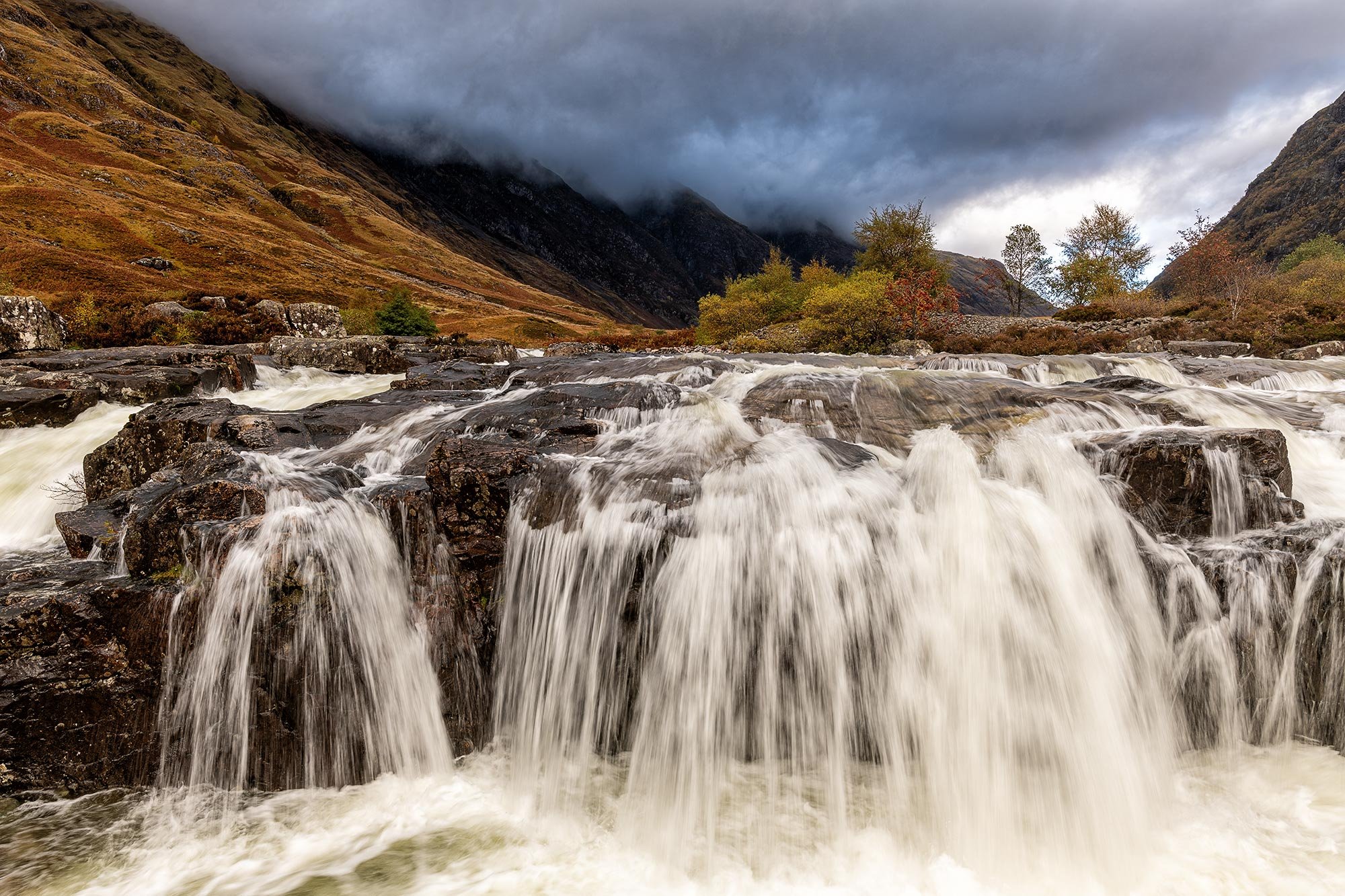 River Coe waterfall in Glencoe on a moody morning in the Scottish mountains
