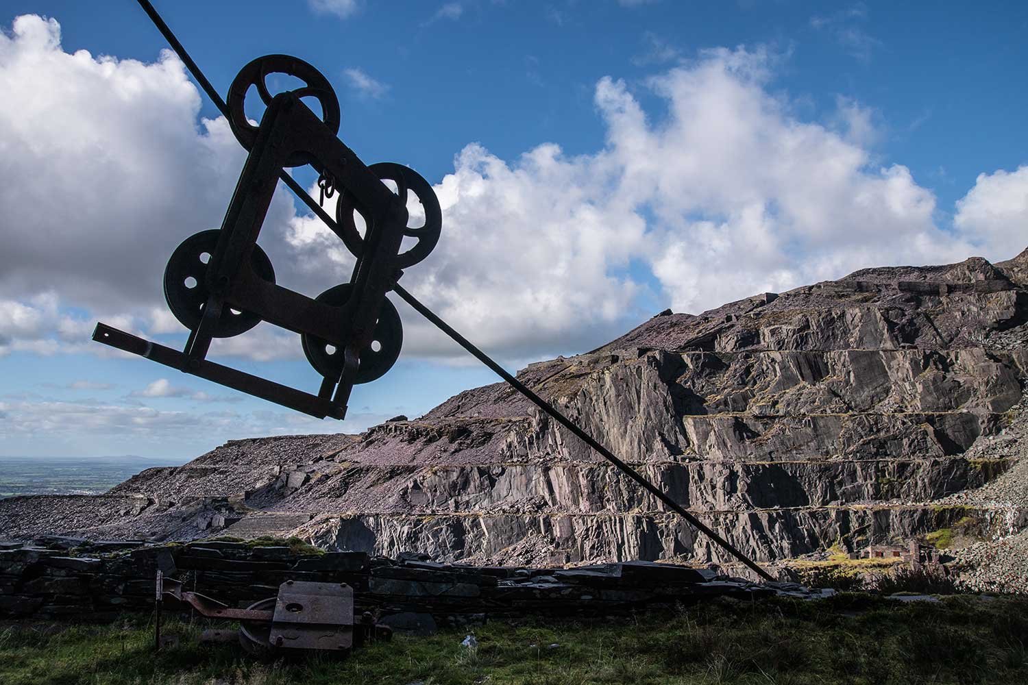An old pulley wheel hangs above the slate quarry working in Dinorwic quarry