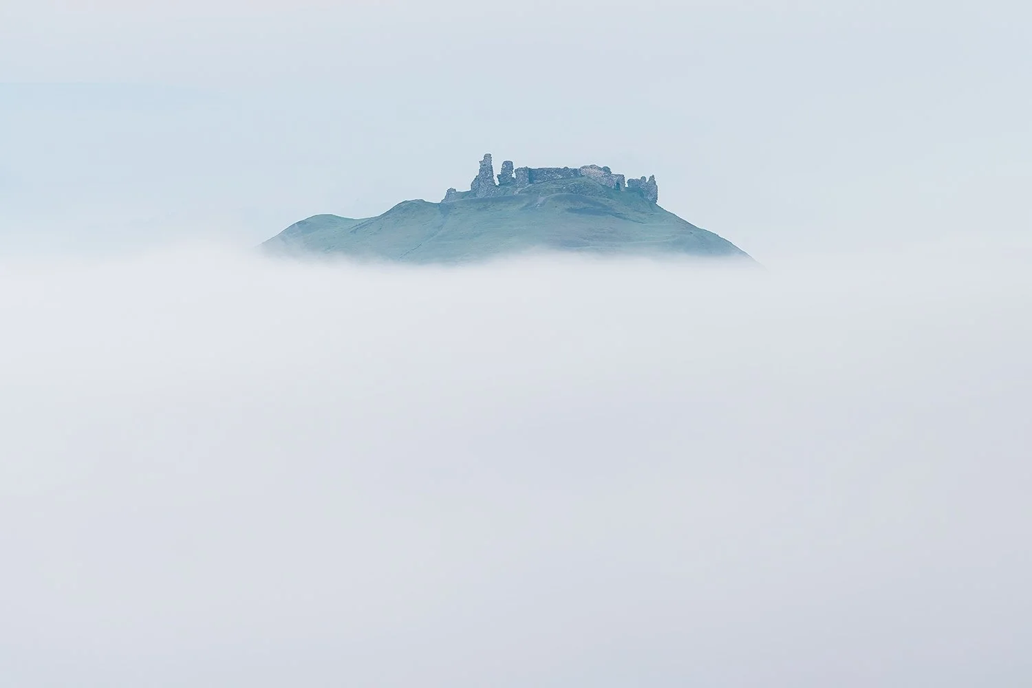 Castell Dinas Bran peeking above the mist in the Dee valley