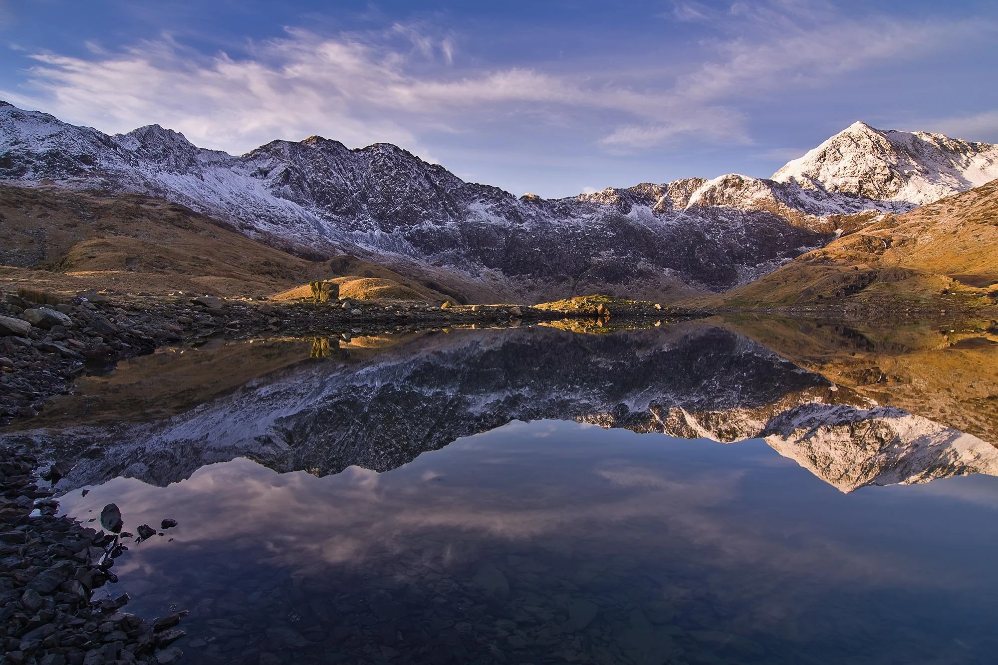 A snow-capped Yr Wyddfa Snowdon Horseshoe reflected in Llyn Llydaw