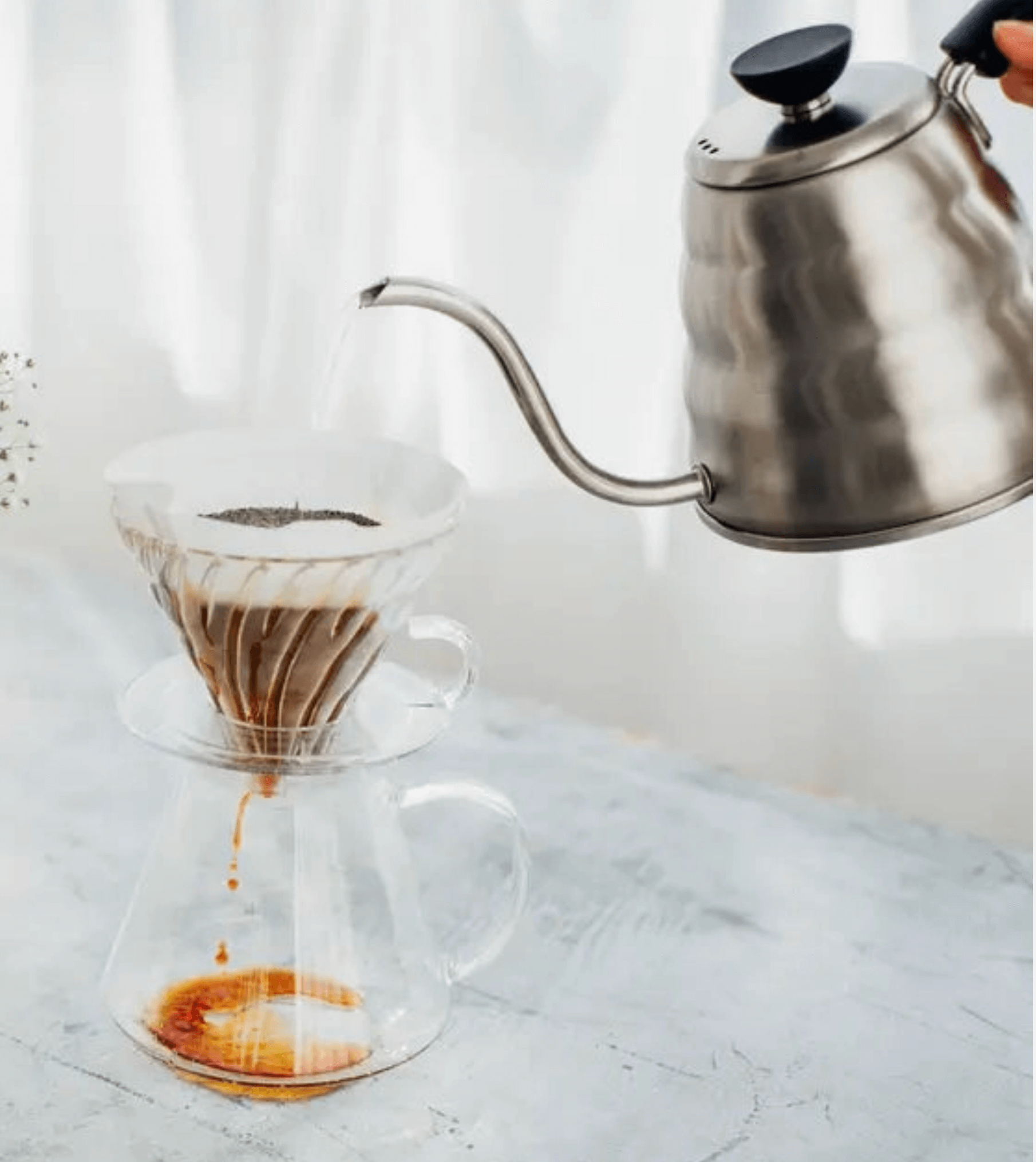 All-glass Hario V60 pour-over brewing kit showing dripper and server.