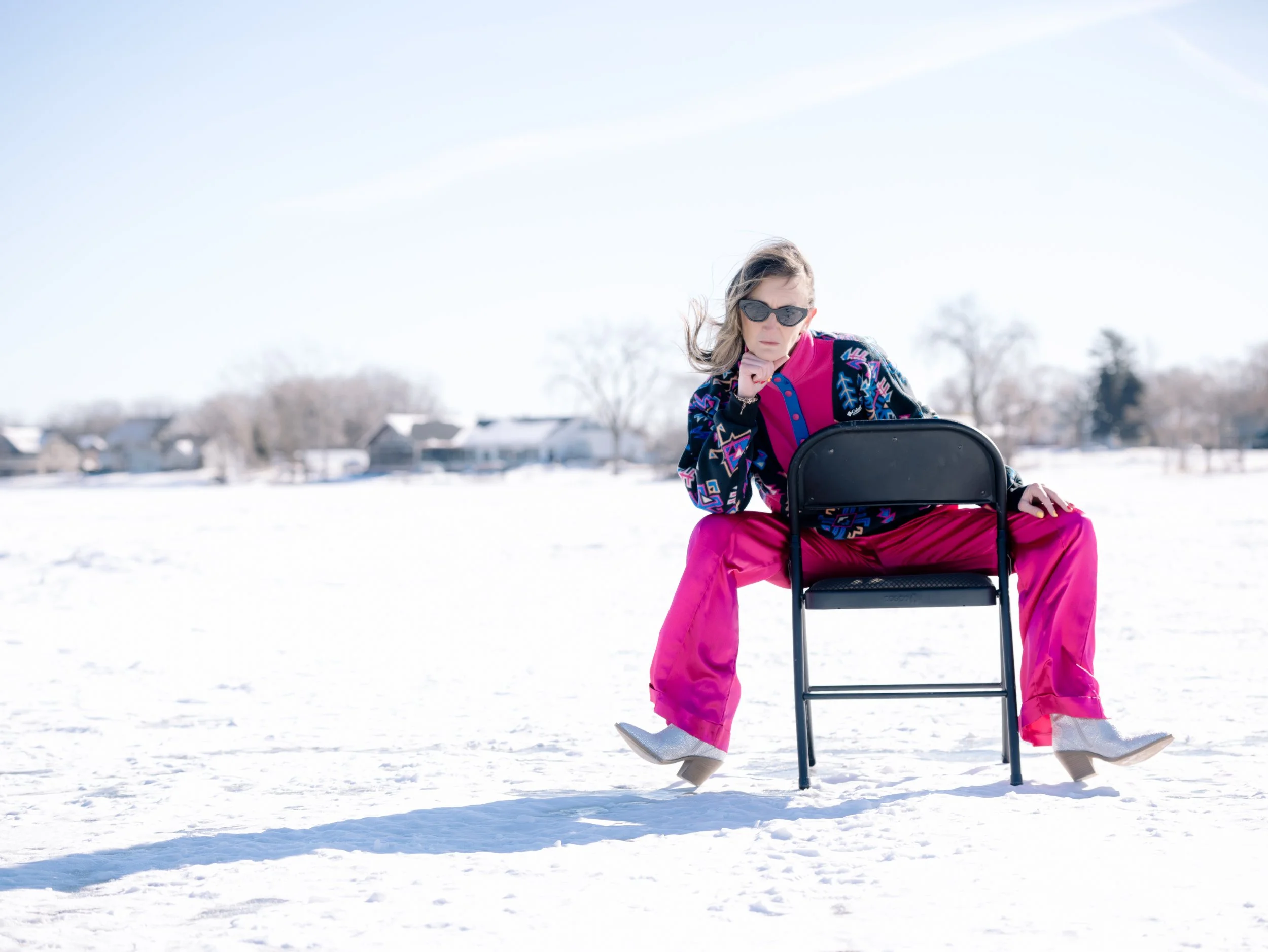 Photo of Julia Brolin sitting on a chair on a frozen lake