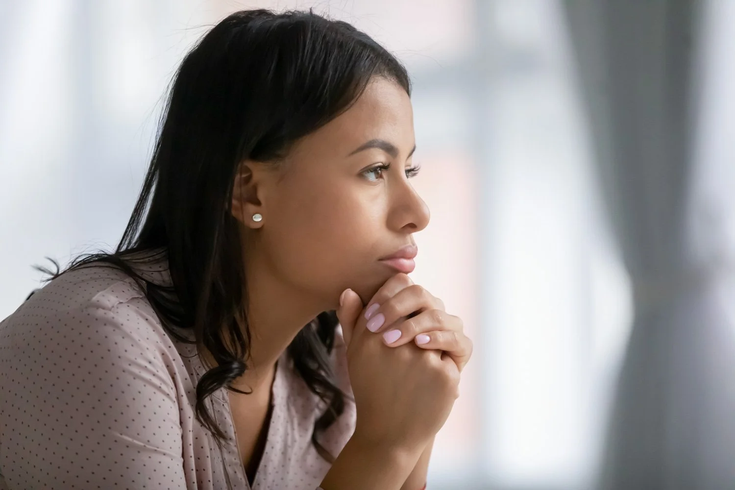Woman thinking about the struggles that come with starting a new business.