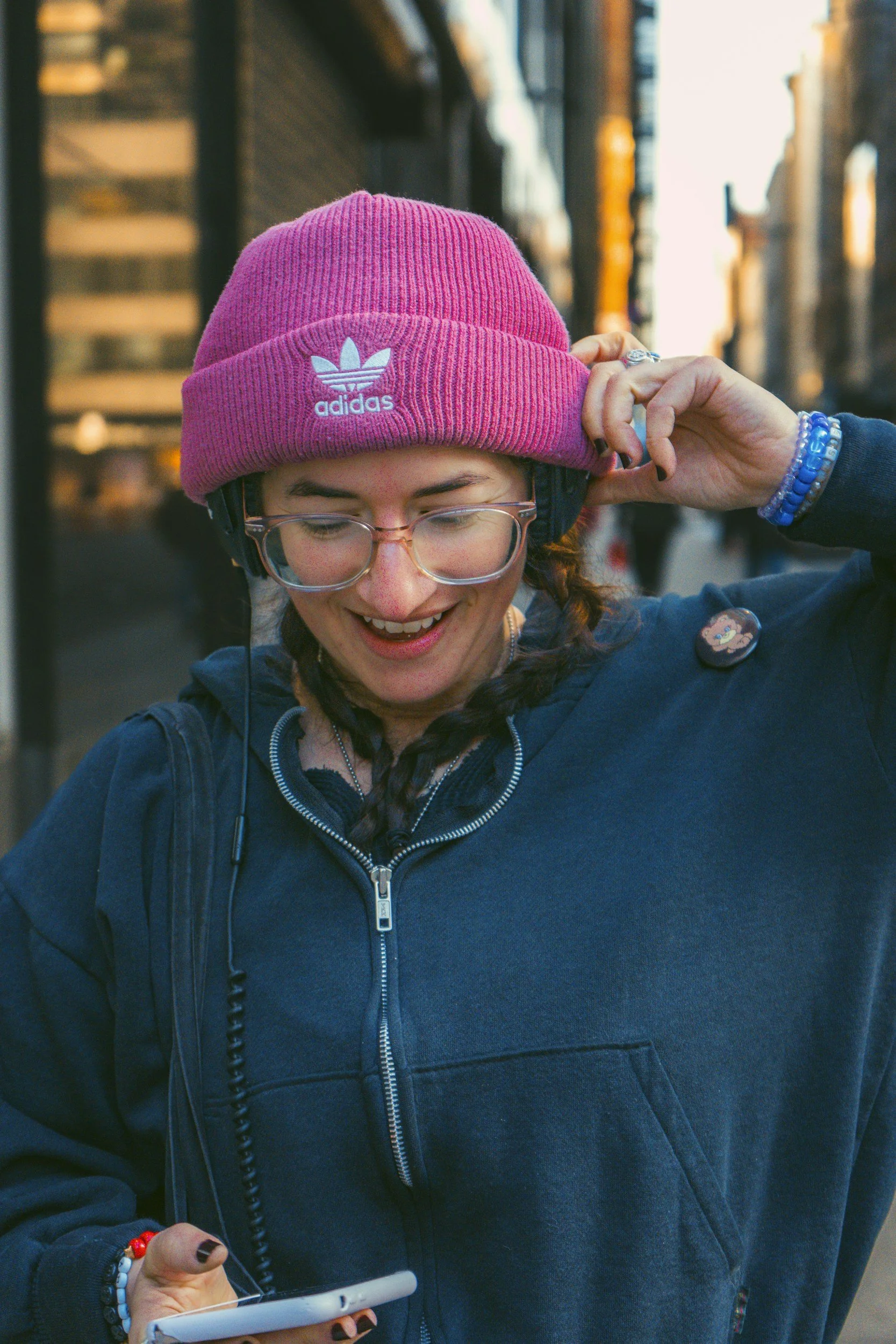 A neurodivergent person smiles while looking down, representing the need for autism, ADHD, bipolar informed therapy with Utah, Rhode Island, and Idaho therapist Amy Bowen.