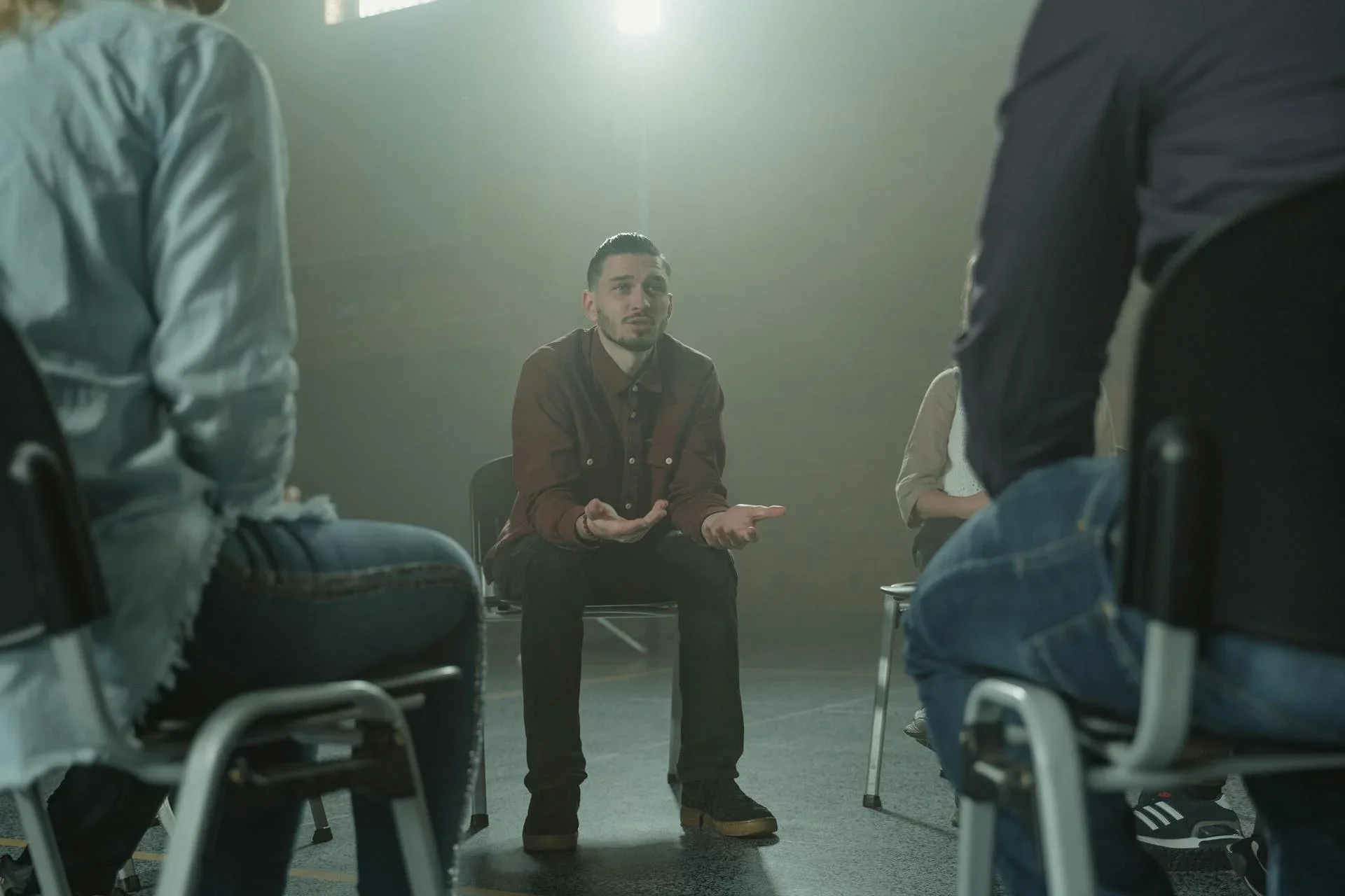 People sit in a group, a representation of Amy Bowen's religious trauma therapy and counseling group for ex mormons in Utah, Rhode Island, and Idaho.