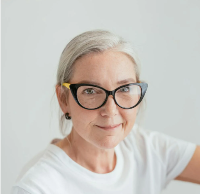 A woman with gray hair smiles, representing a potential client for affirming holistic trauma therapy by therapist Amy Bowen in Hyde Park, Utah.