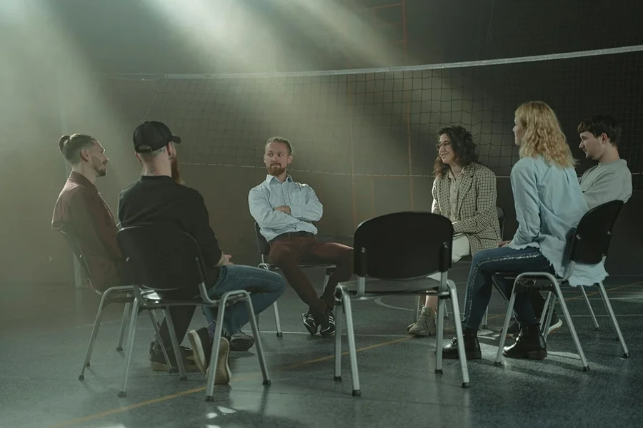 A group sits together, representing Amy Bowen's therapy and counseling groups for self esteem and narcissistic abuse recovery.