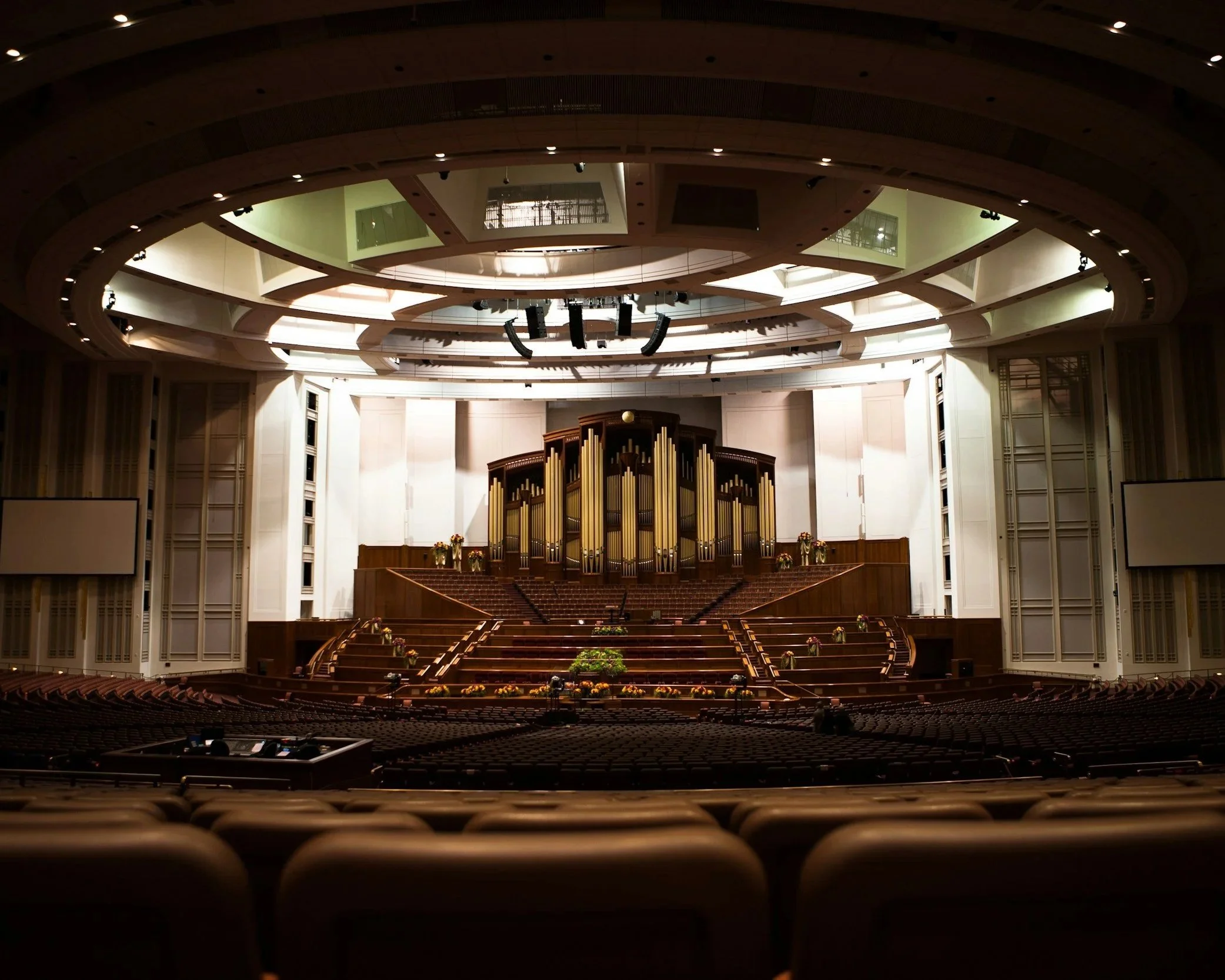 Interior of a large auditorium with a historic pipe organ; reflecting the landscape of LDS faith transitions and religious deconstruction in Utah.