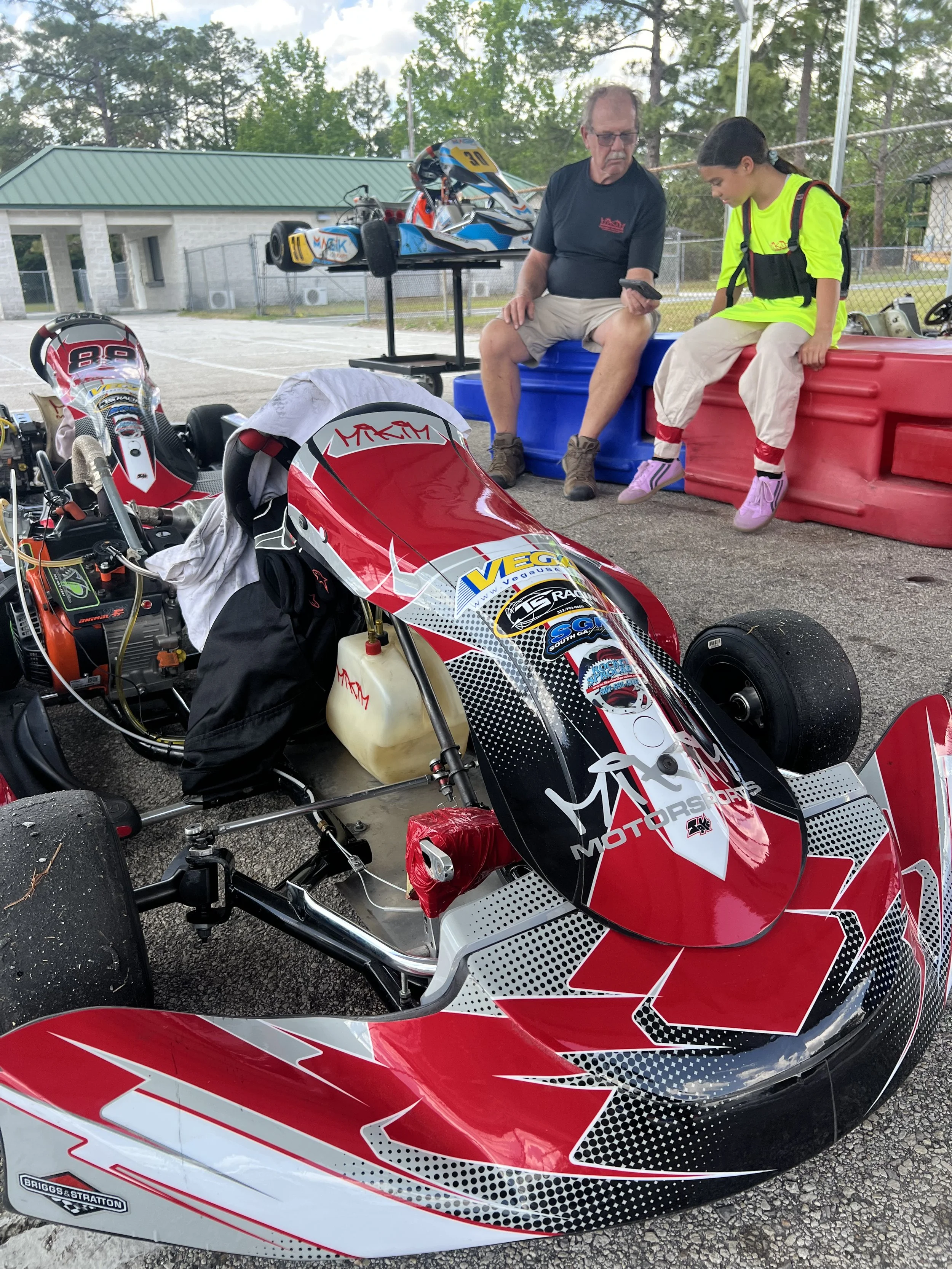 Karts lined up on the grid coaching a new young driver